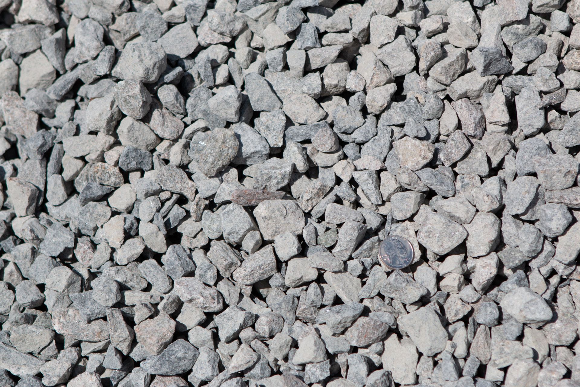 A pile of gravel is sitting on the ground.
