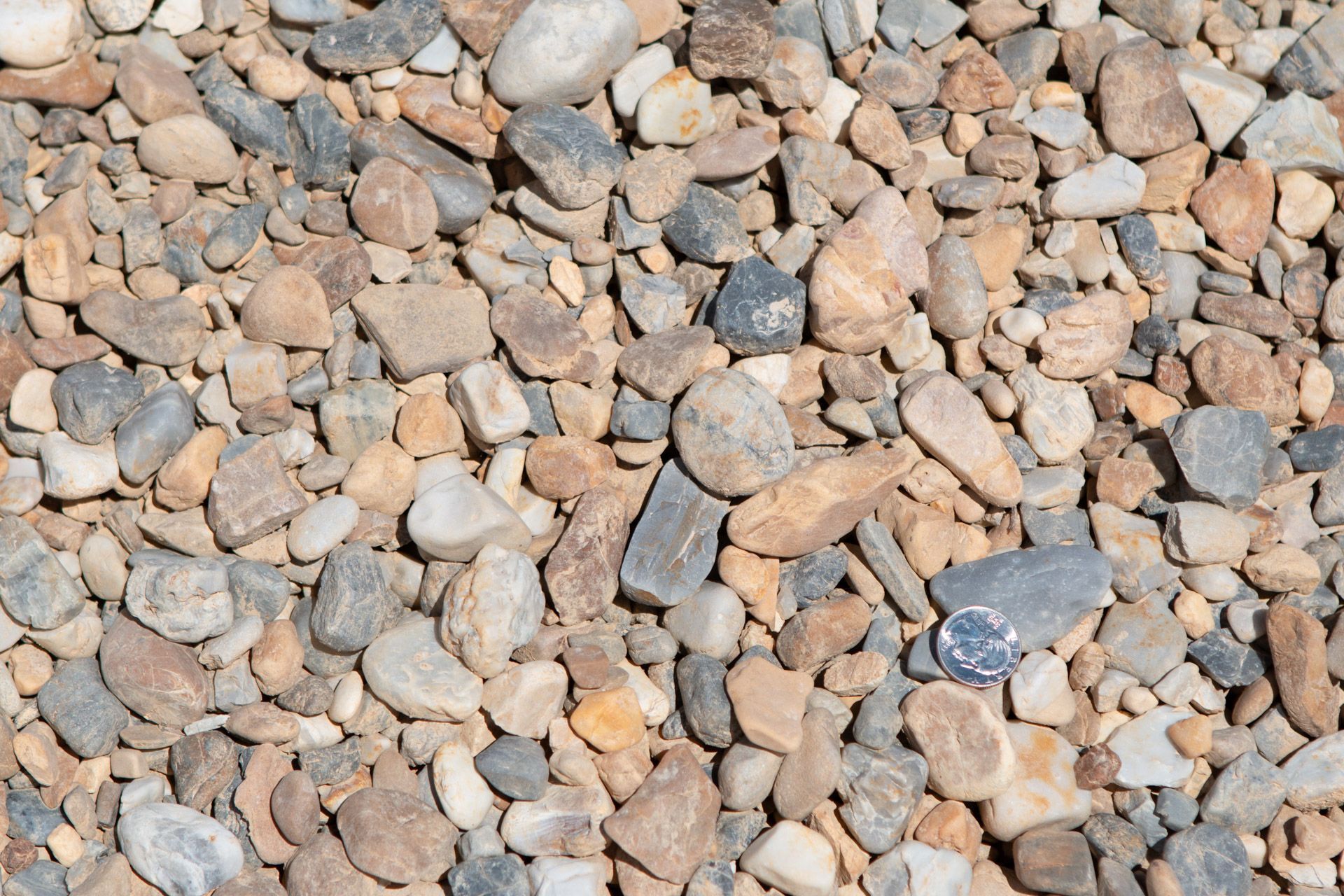 A pile of rocks with a coin in the middle.