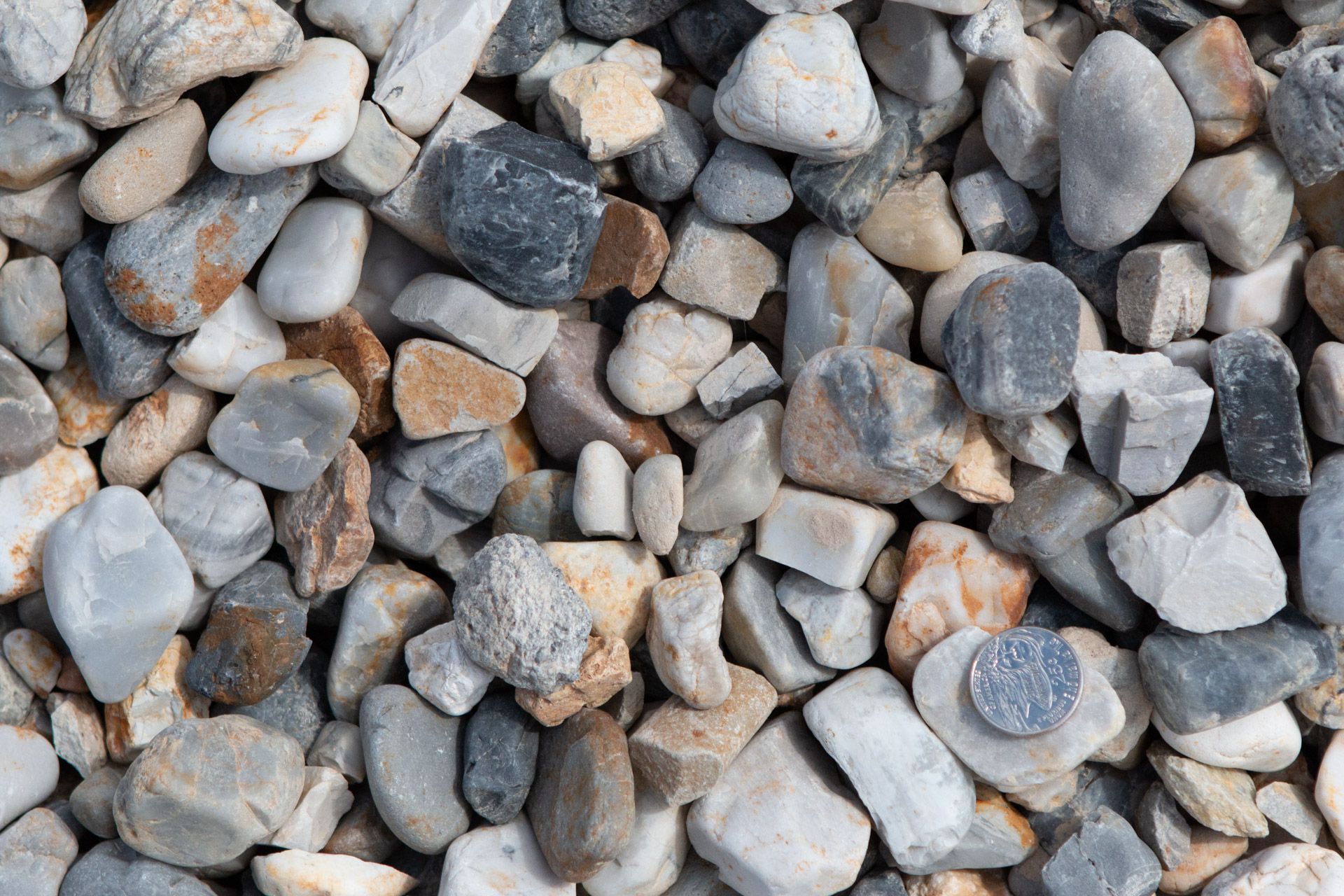 A pile of rocks with a coin in the middle.