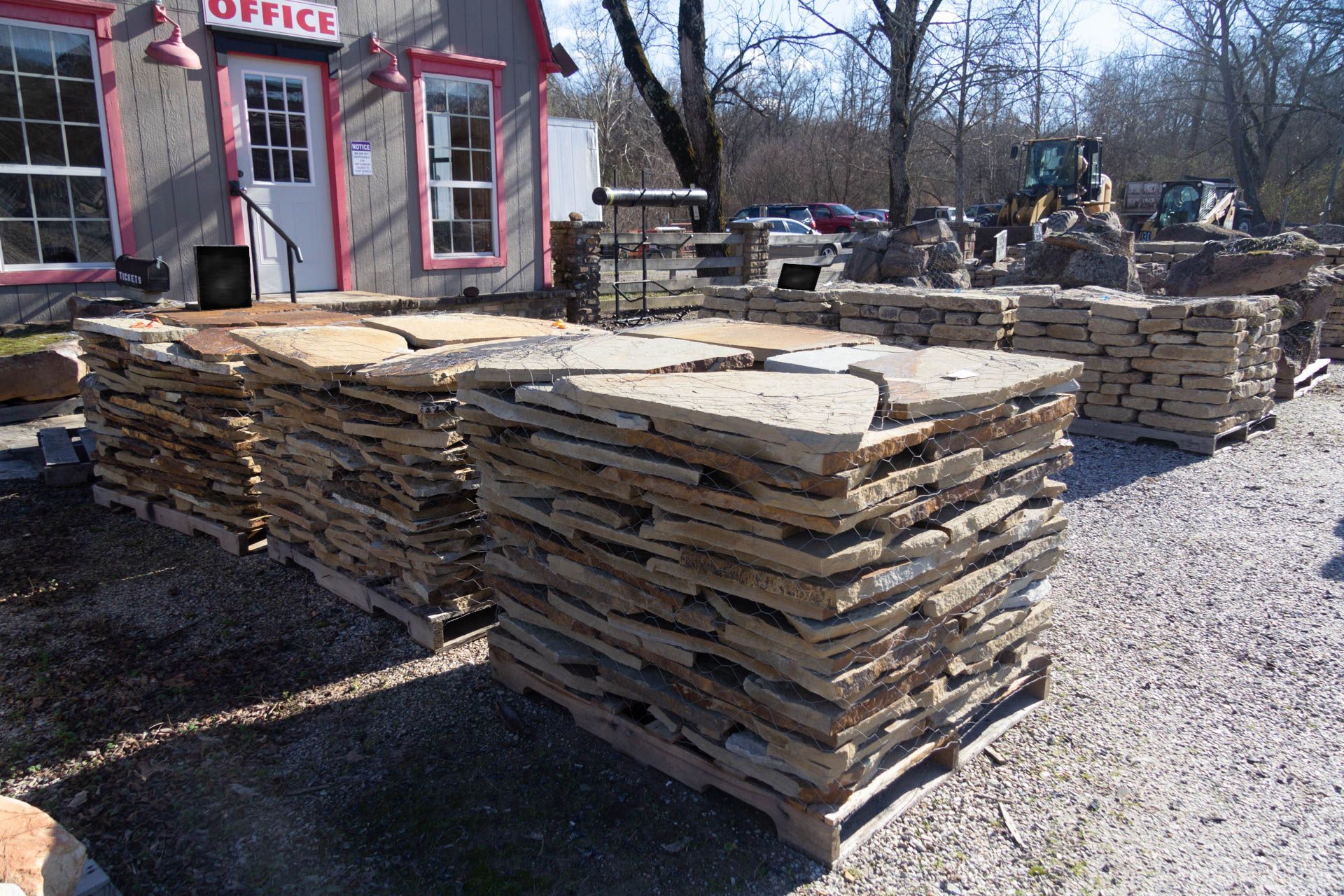 A stack of wooden pallets in front of an office
