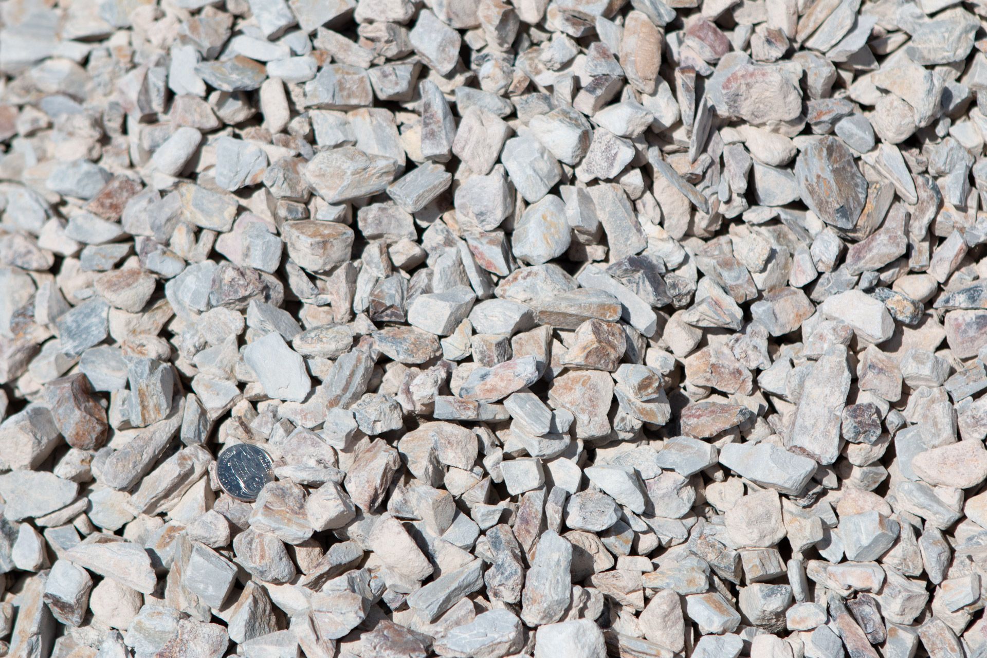A pile of gravel is sitting on the ground.