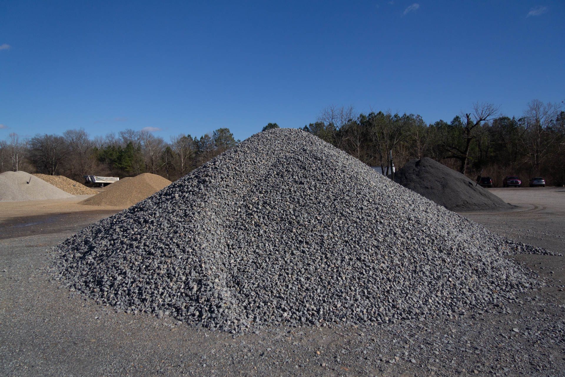 A pile of gravel is sitting in the middle of a field