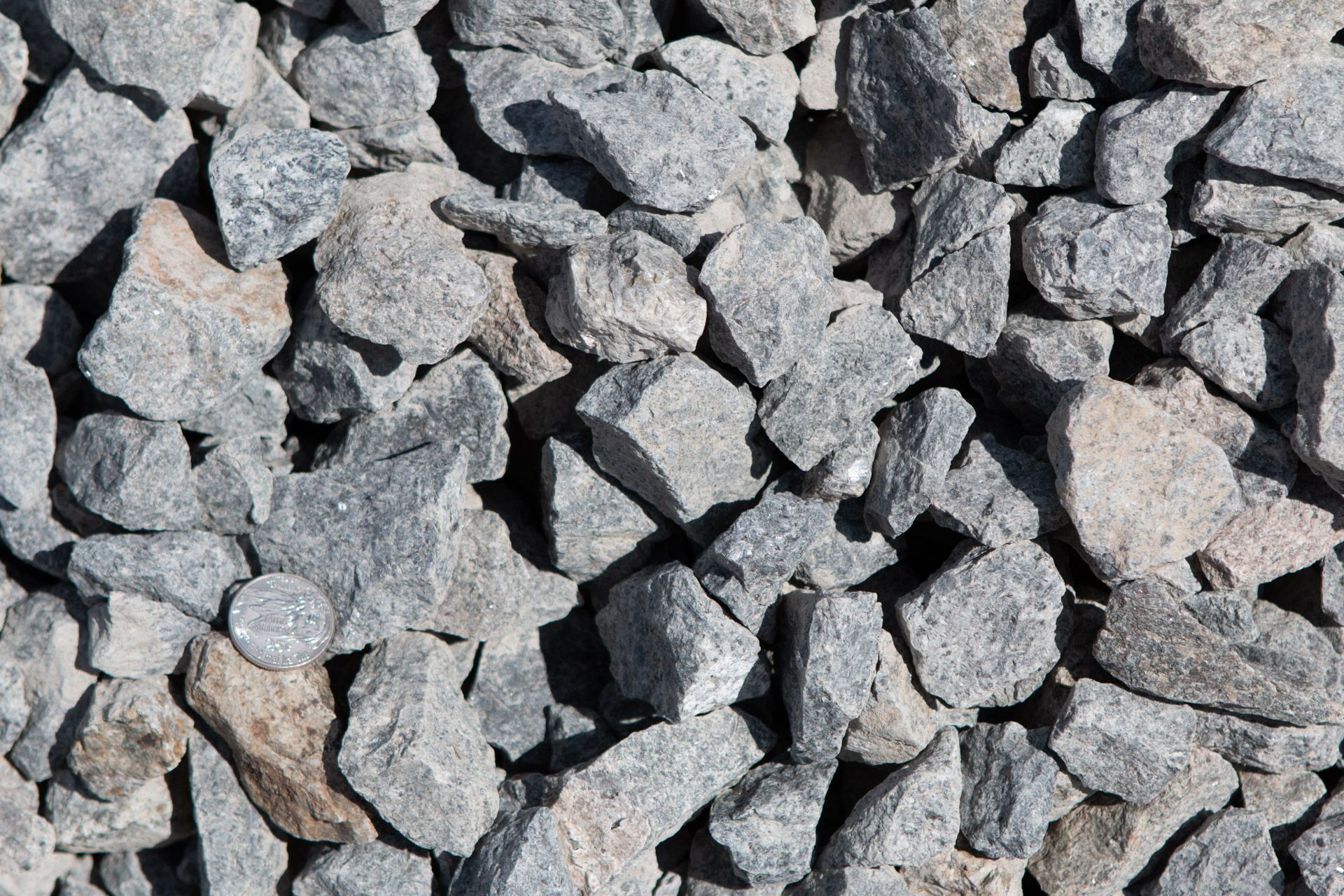 A pile of rocks is sitting on the ground.