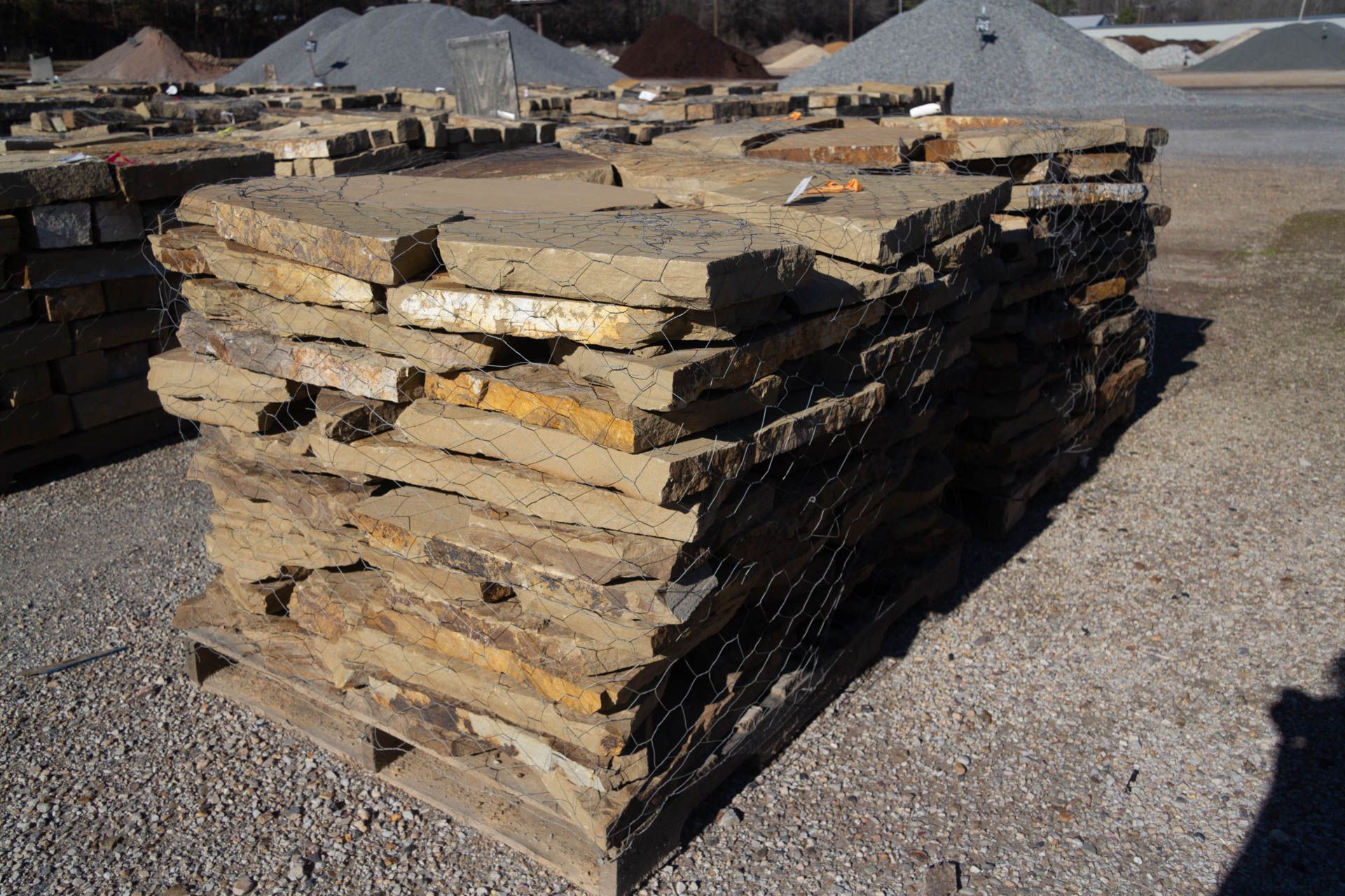 A pile of rocks is stacked on top of each other on a wooden pallet.