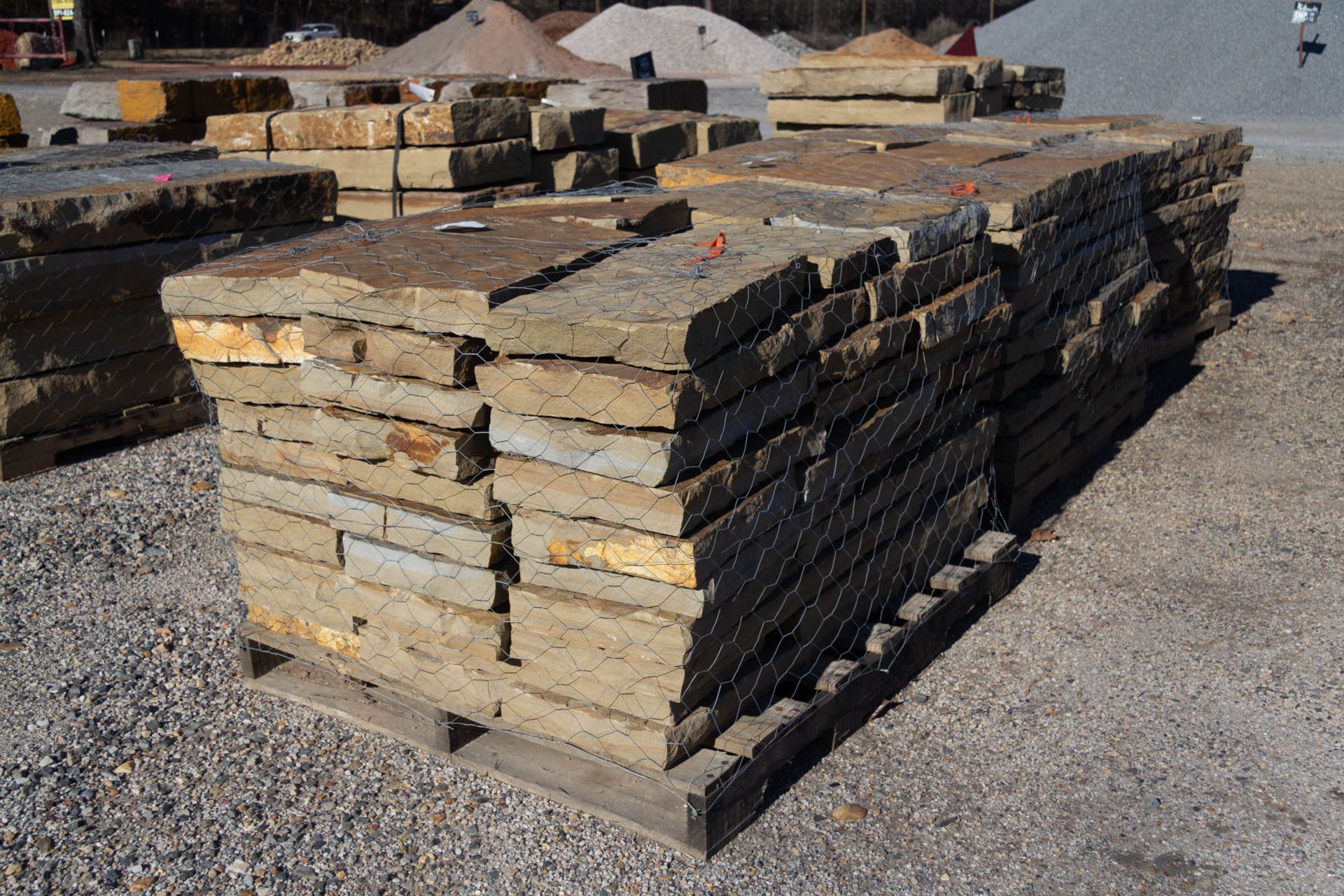 A pile of bricks stacked on top of each other on a wooden pallet