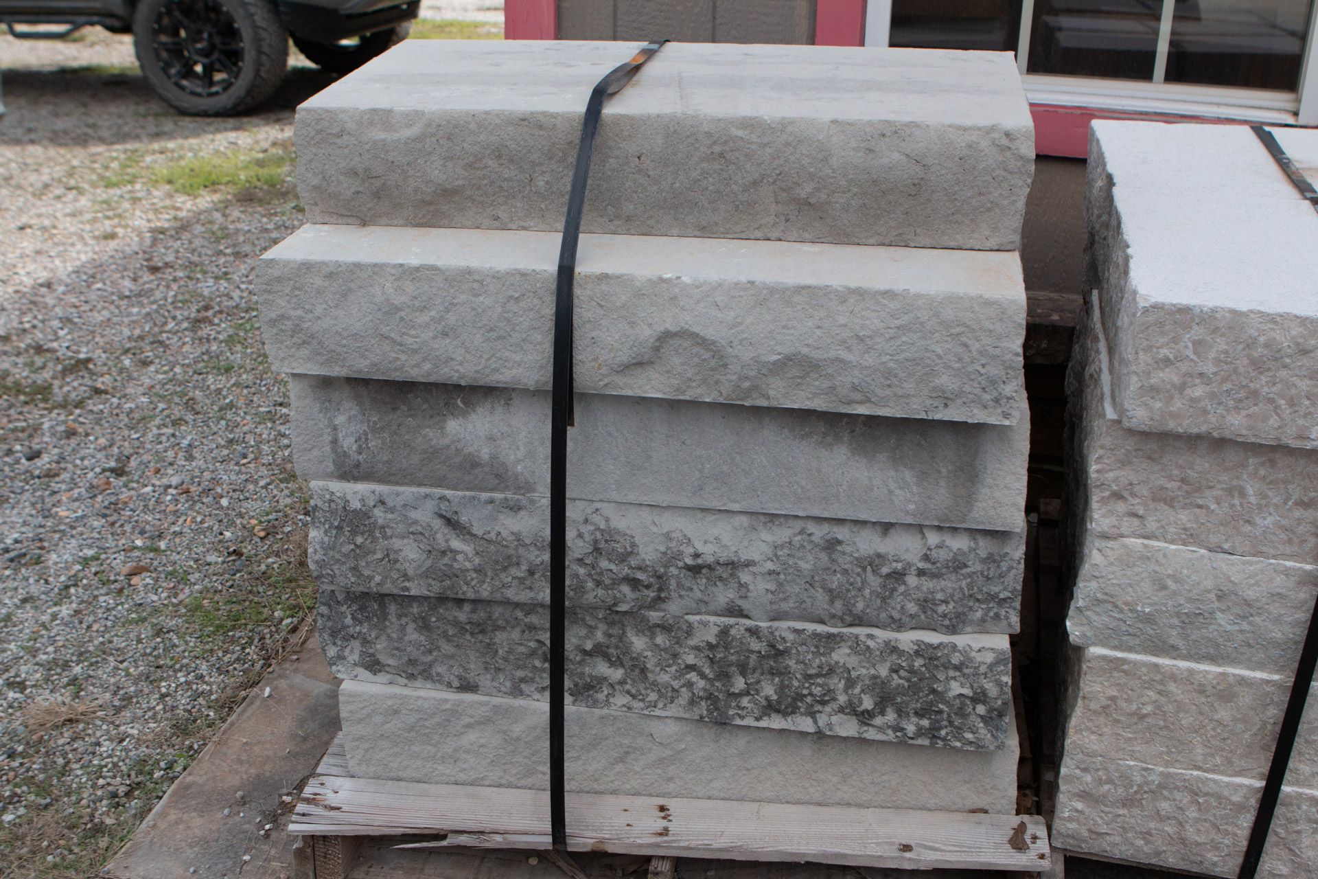 A stack of concrete blocks tied together with a black strap