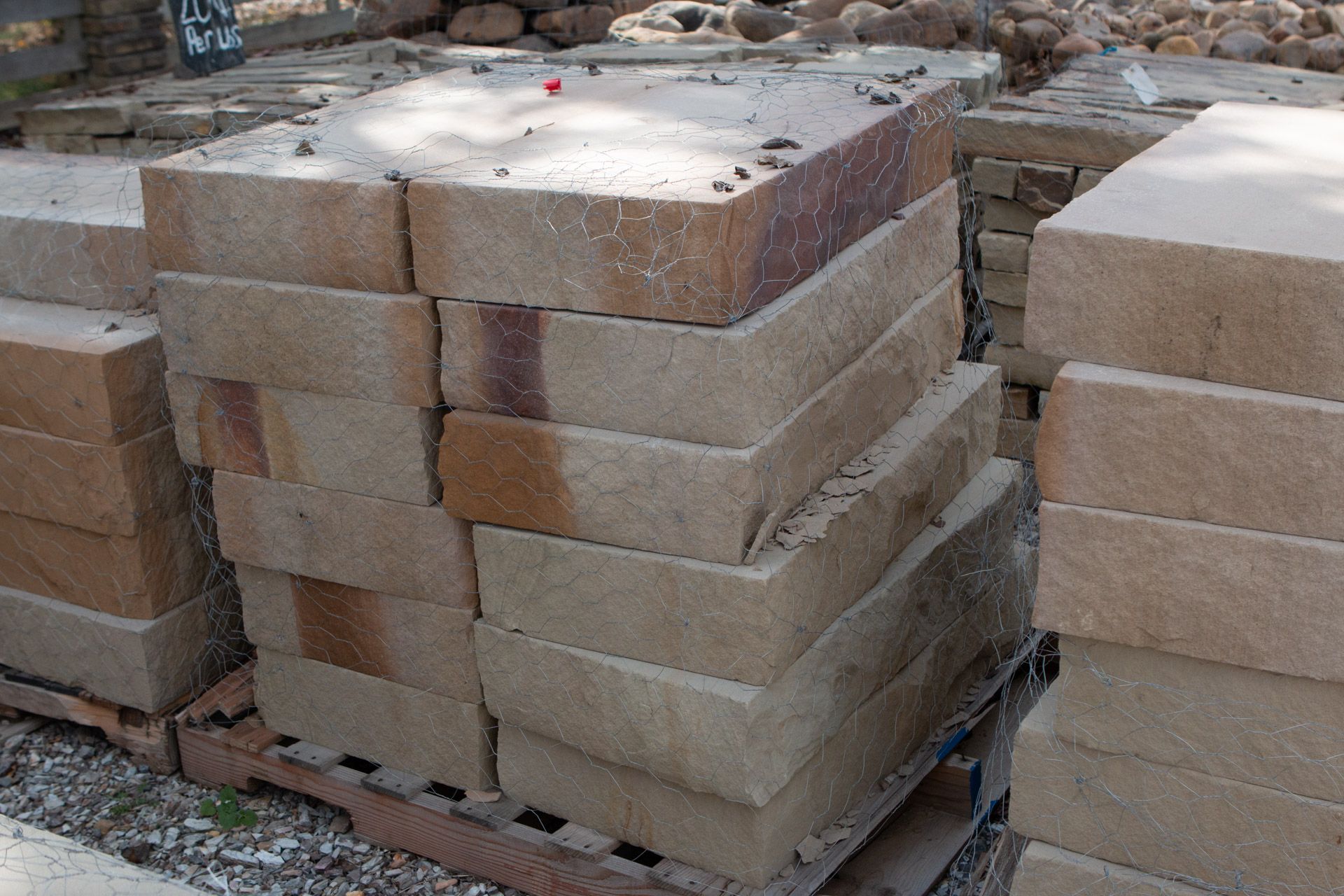 A pile of bricks stacked on top of each other on a wooden pallet