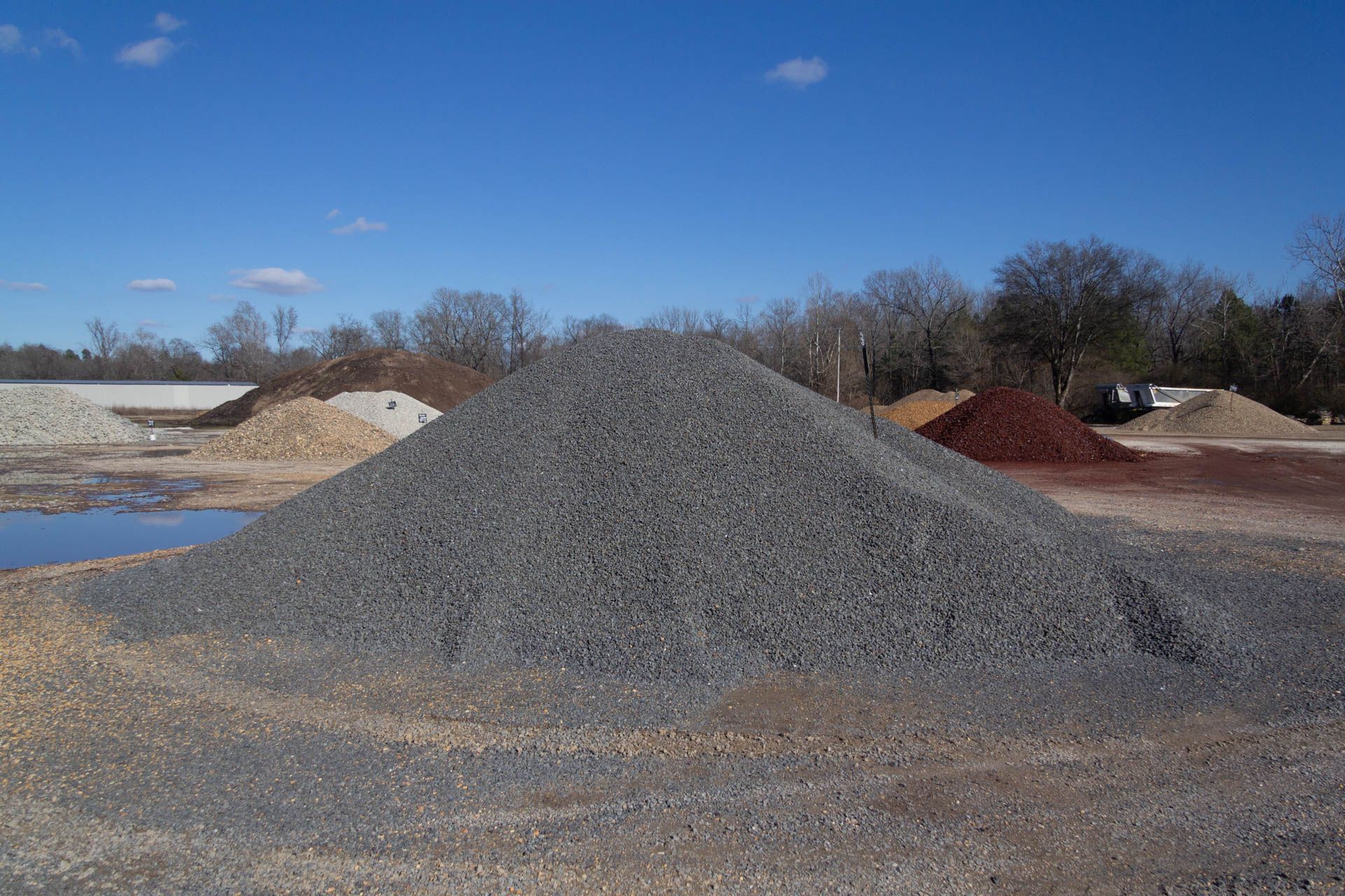 A pile of gravel is sitting on top of a dirt field.