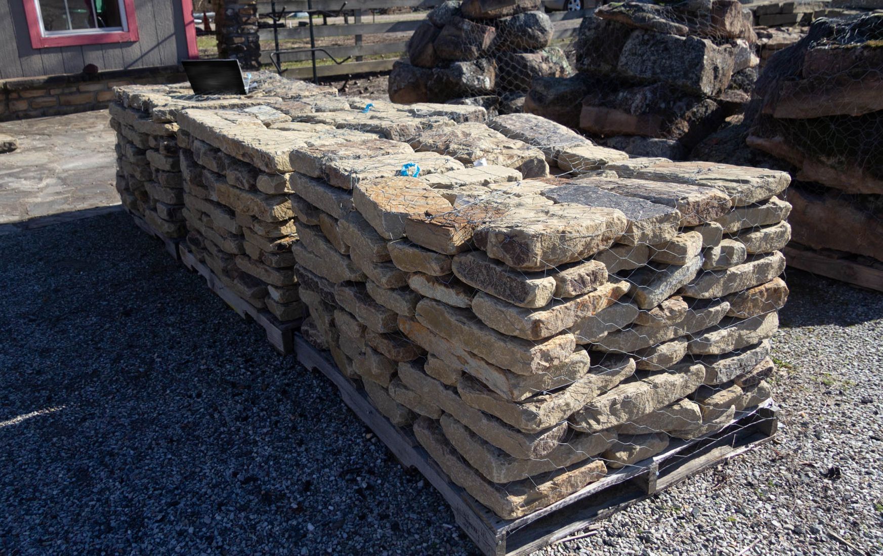 A pile of rocks stacked on top of each other on a wooden pallet.