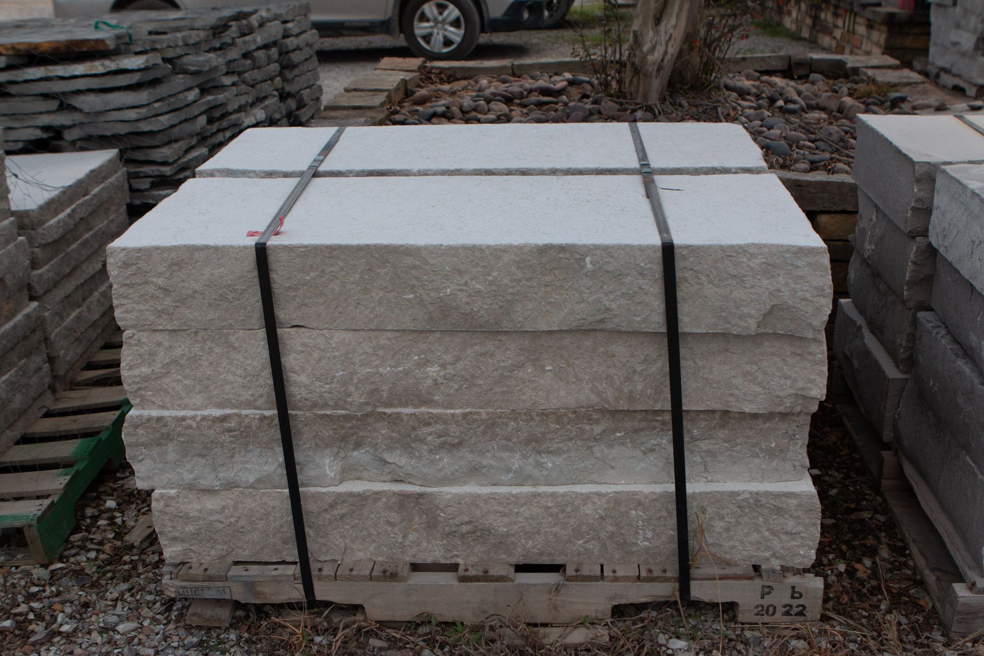 A stack of concrete slabs tied together with black straps