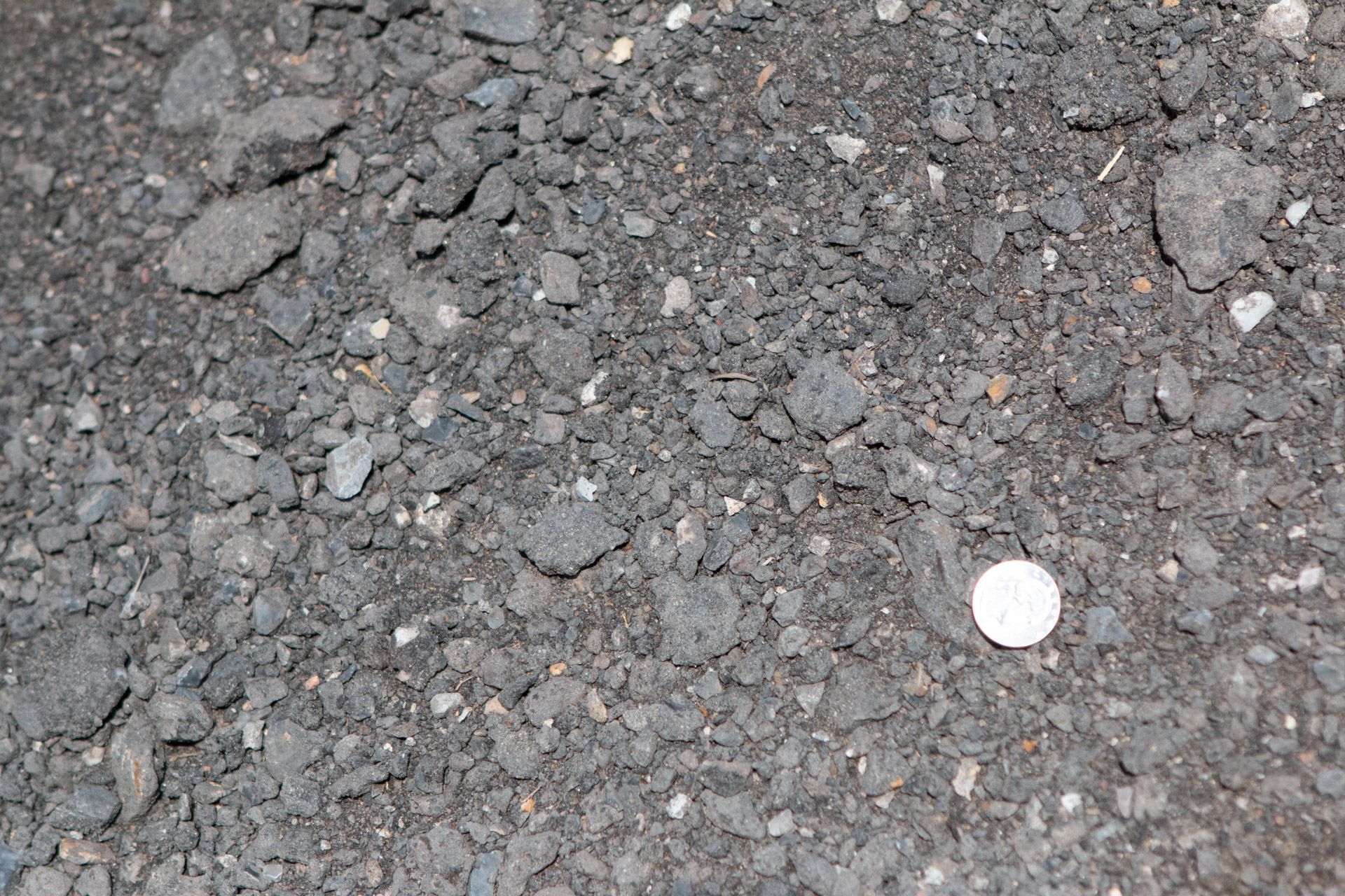 A pile of rocks with a coin in the middle.