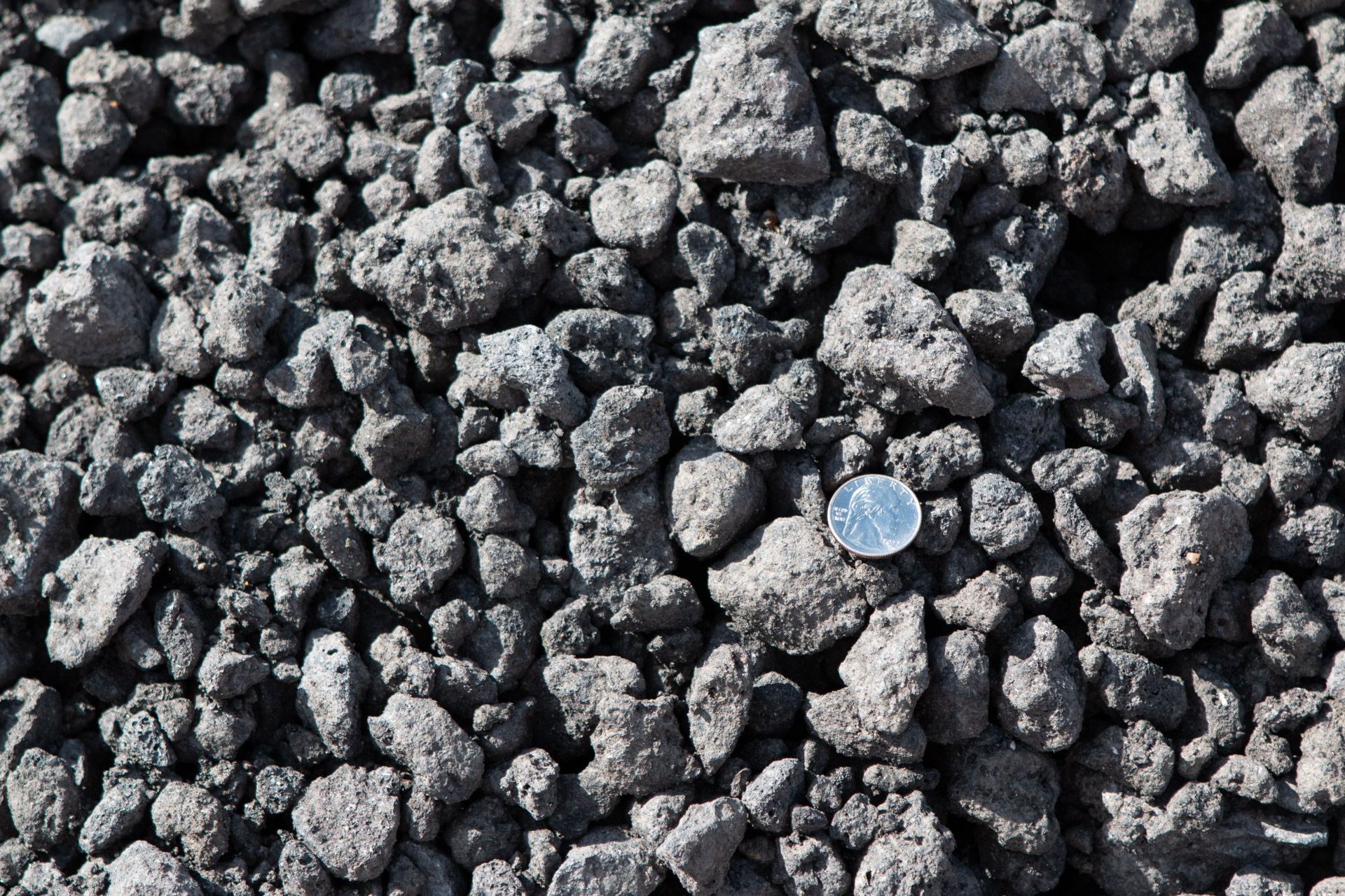 A pile of rocks with a coin in the middle