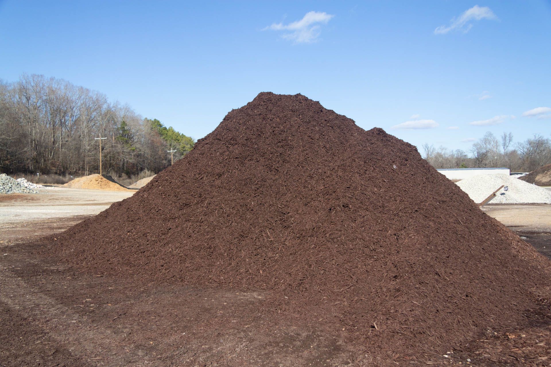 A large pile of dirt is sitting on top of a dirt field.
