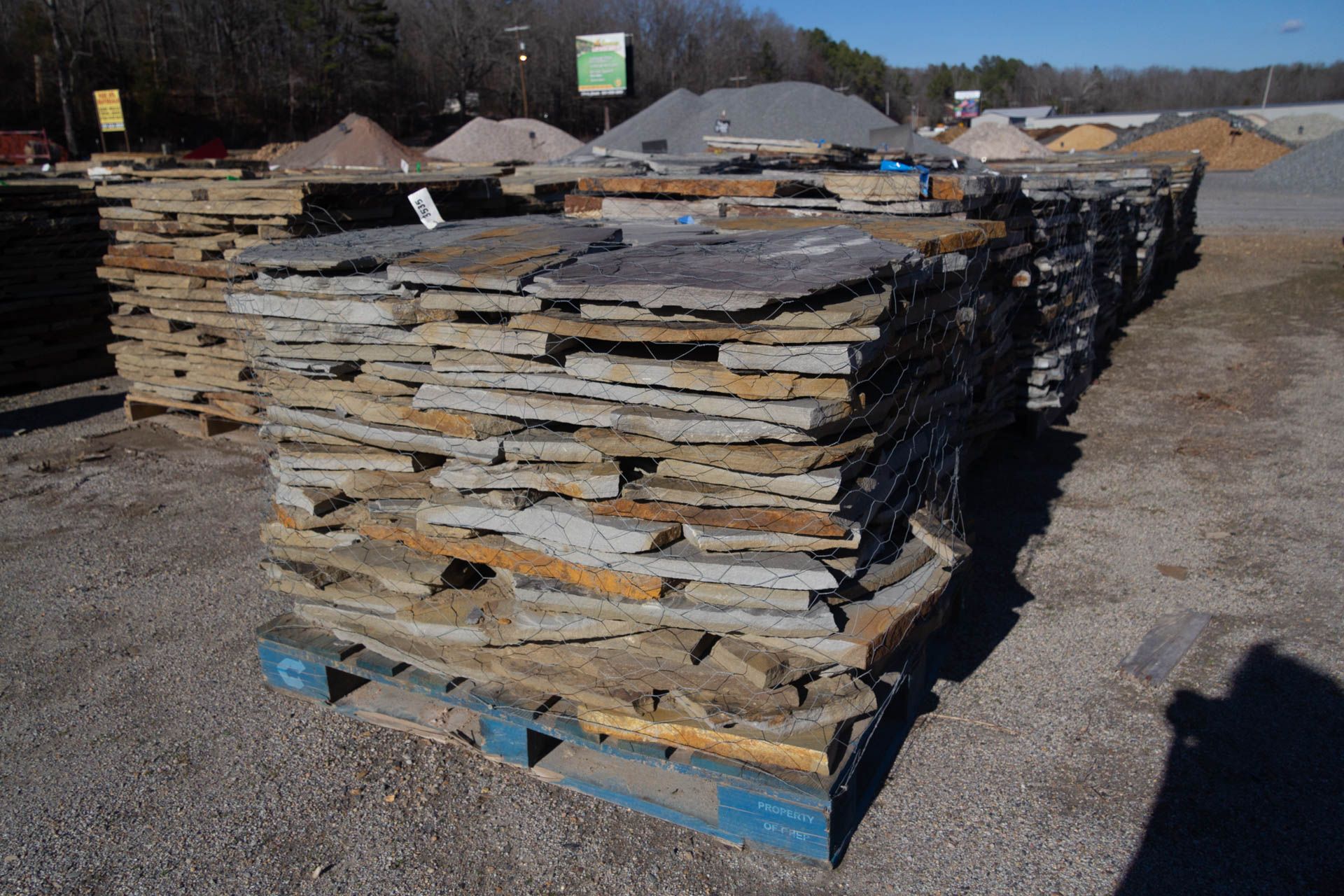 A pile of rocks is stacked on top of a wooden pallet.