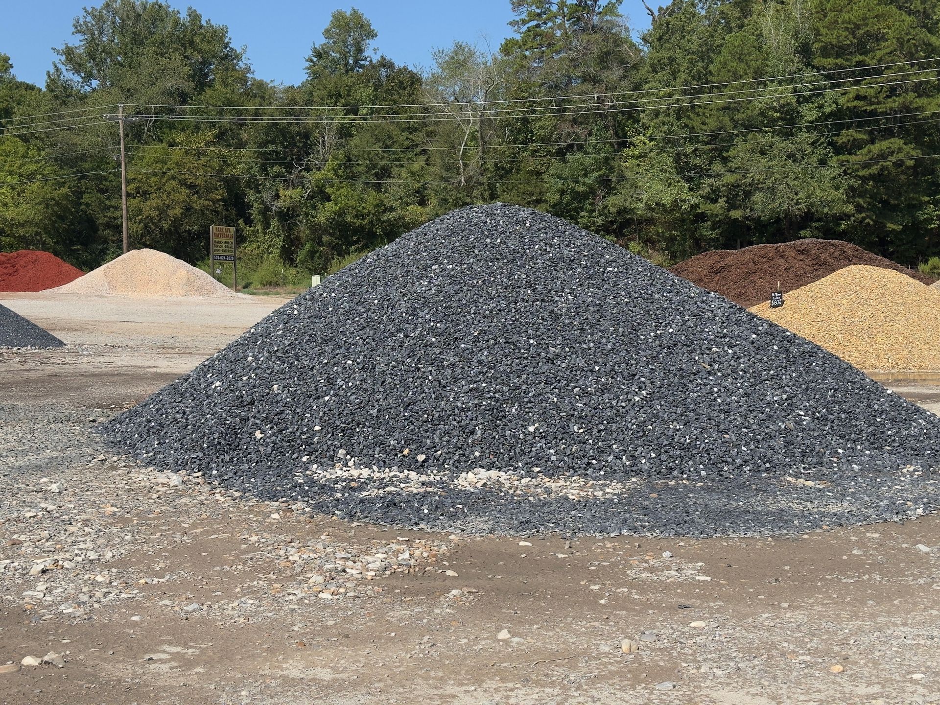 A pile of gravel is sitting on top of a dirt field.