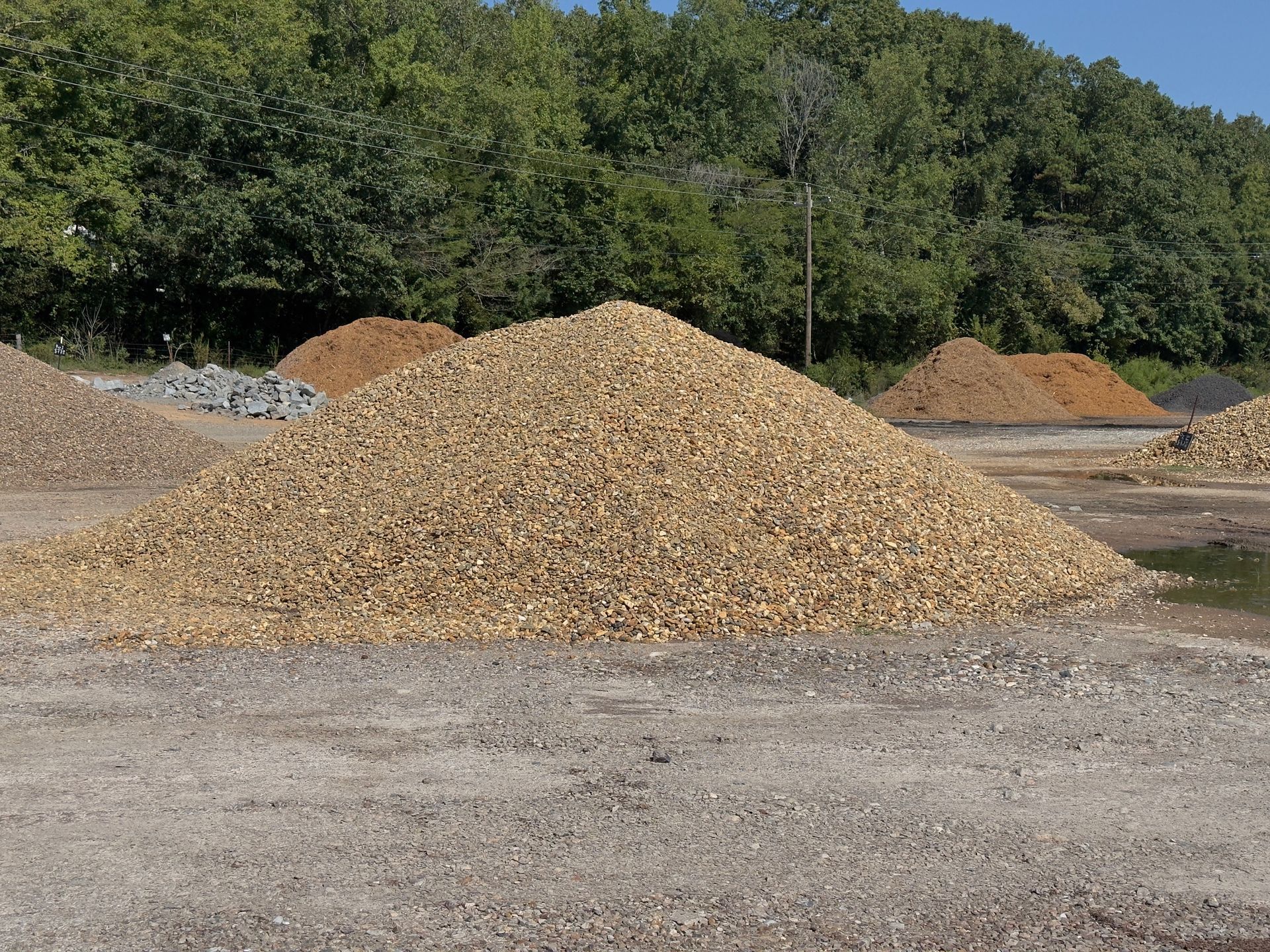 A pile of rocks with a quarter in the middle.