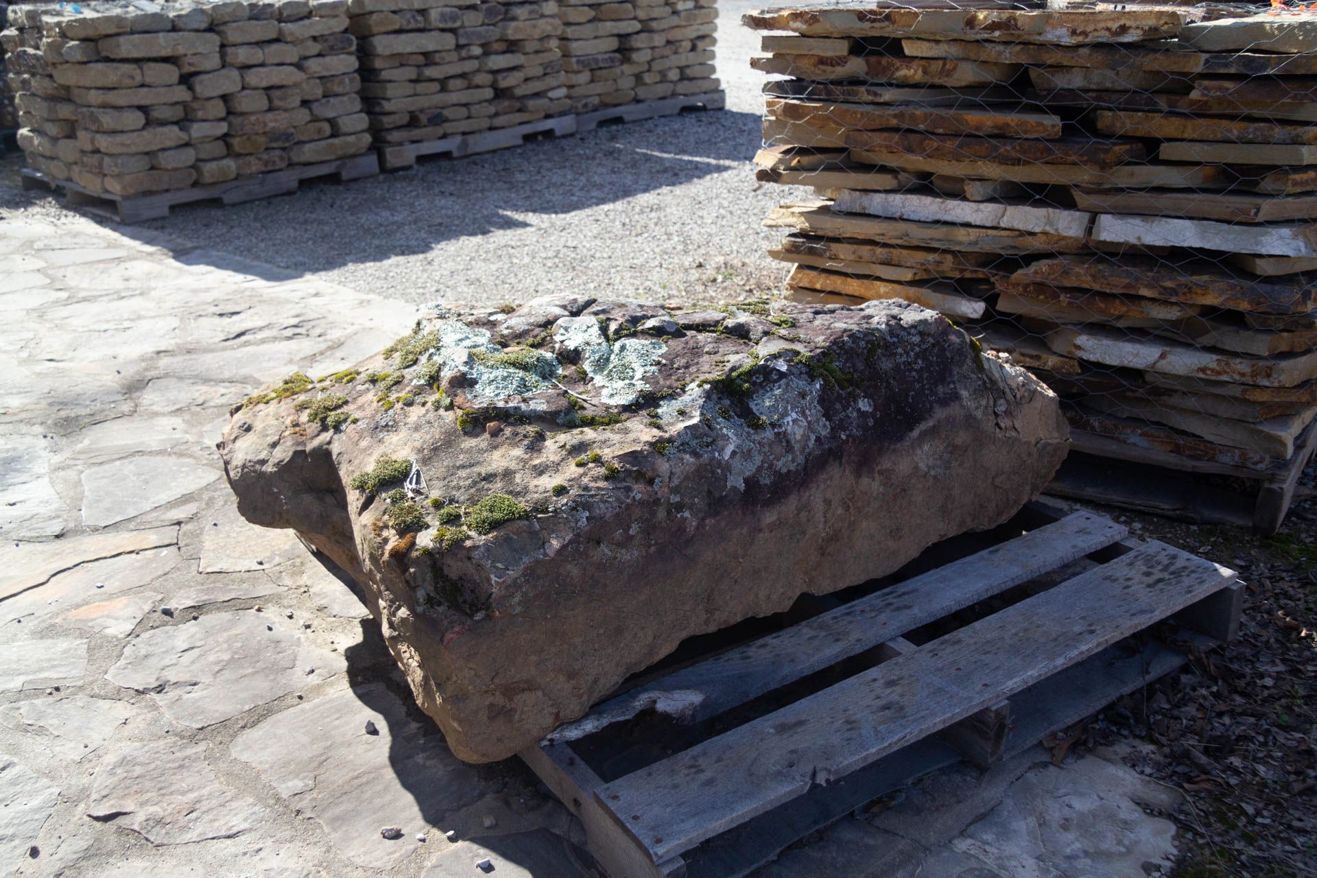 A large rock is sitting on top of a wooden pallet.