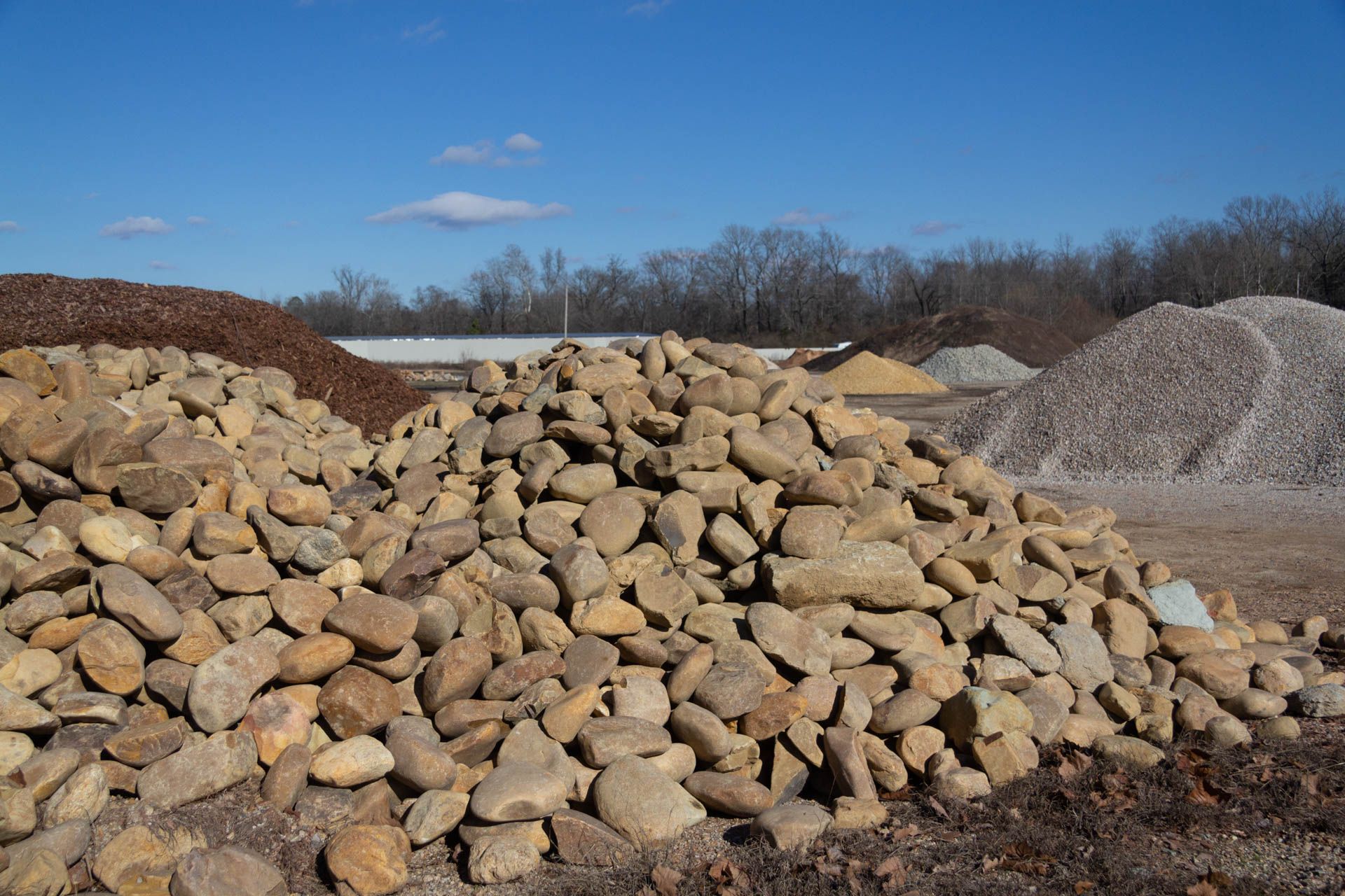 A pile of rocks is sitting on top of a dirt field.