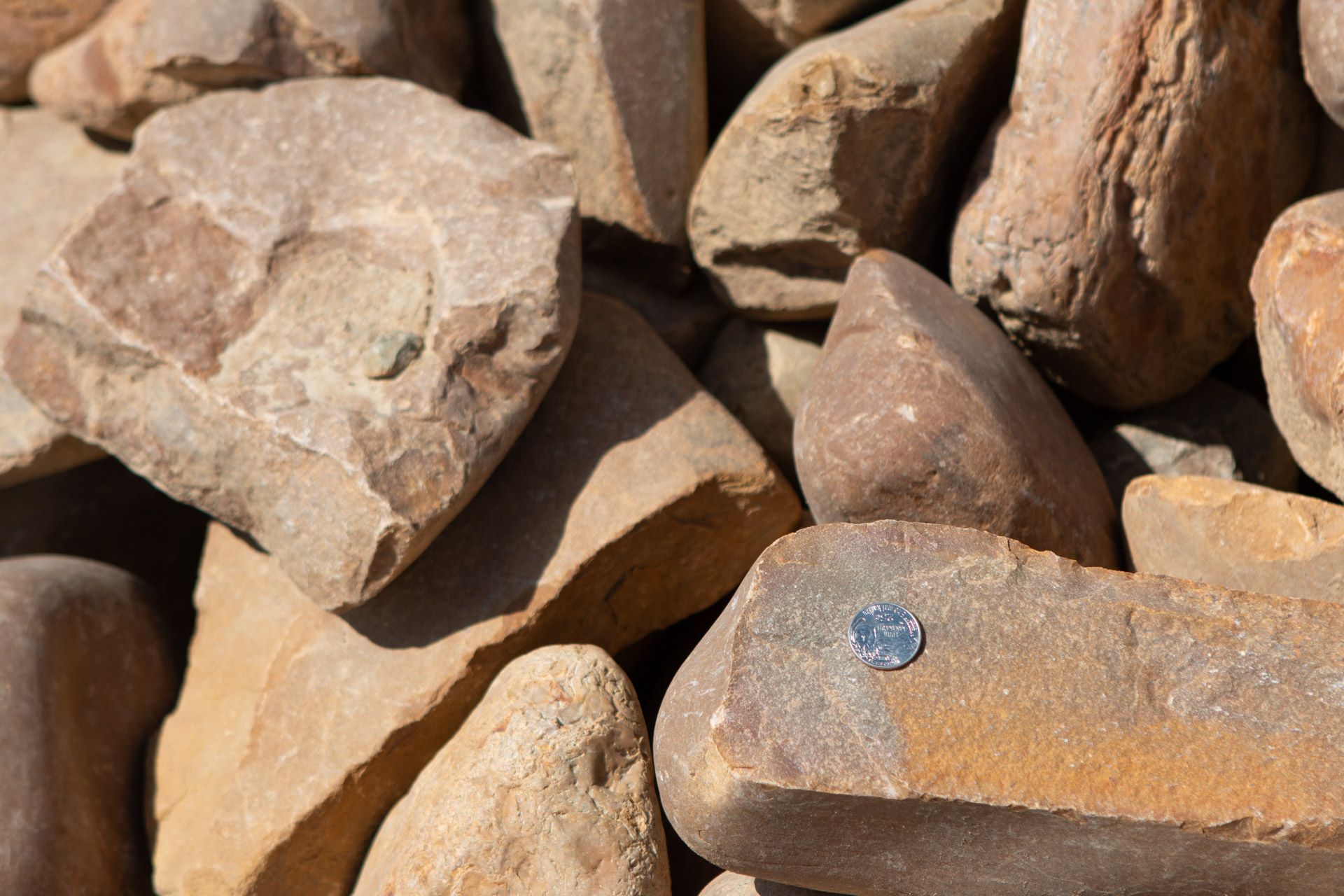 A pile of rocks with a coin in the middle.
