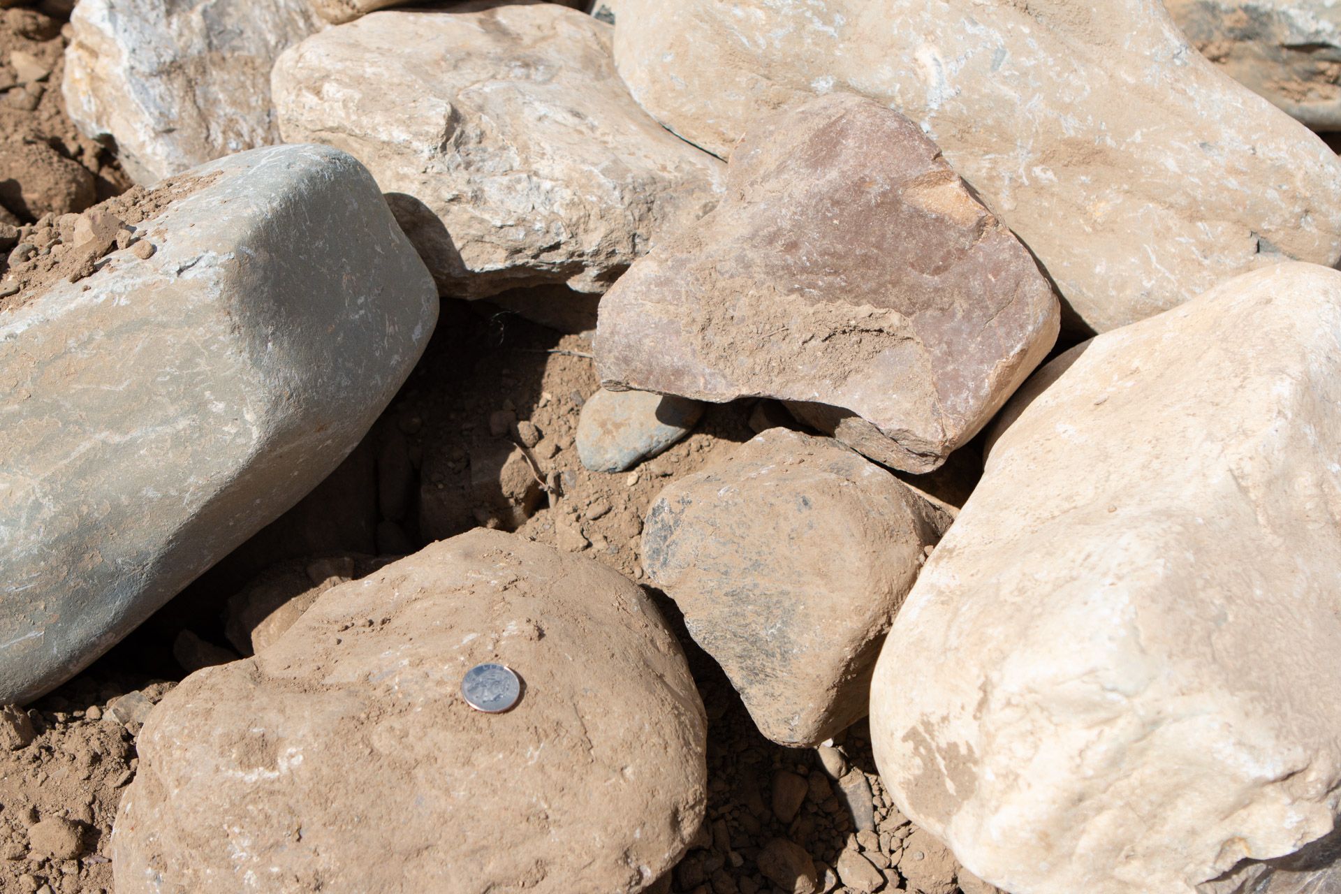 A pile of rocks with a coin in the middle