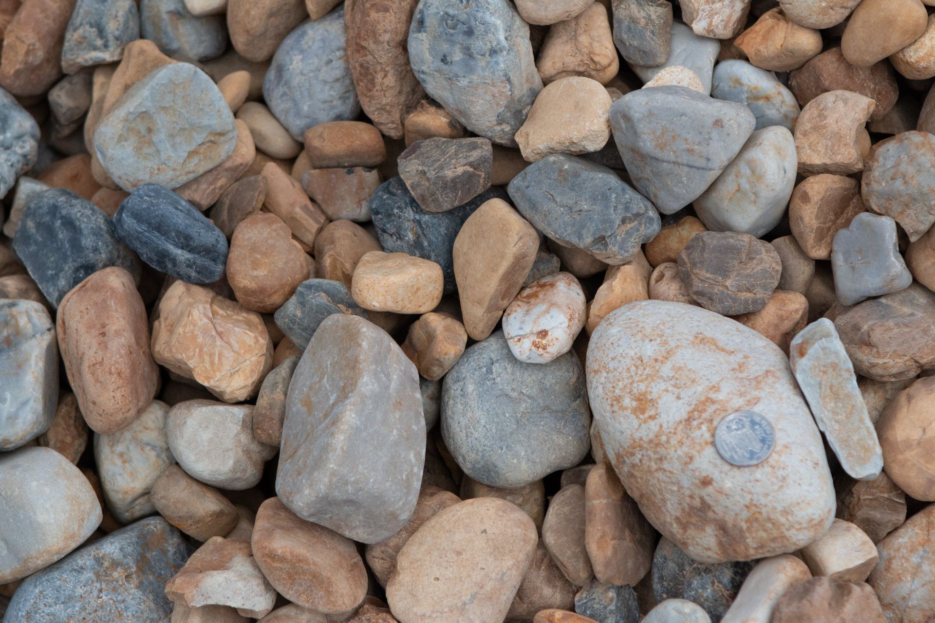 A pile of rocks with a coin in the middle.