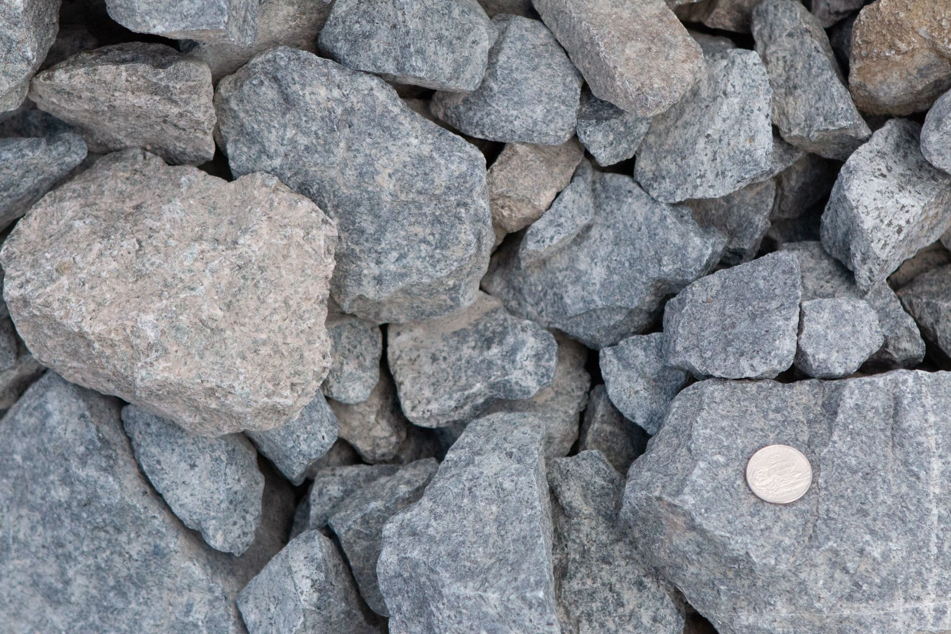 A pile of rocks with a coin in the middle.