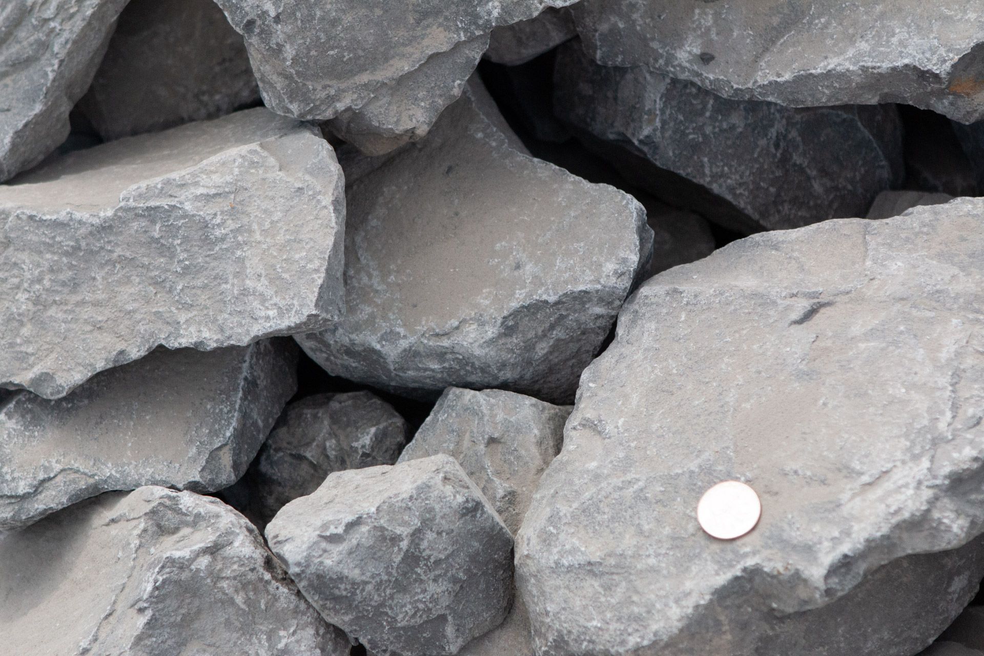 A pile of rocks with a coin in the middle.