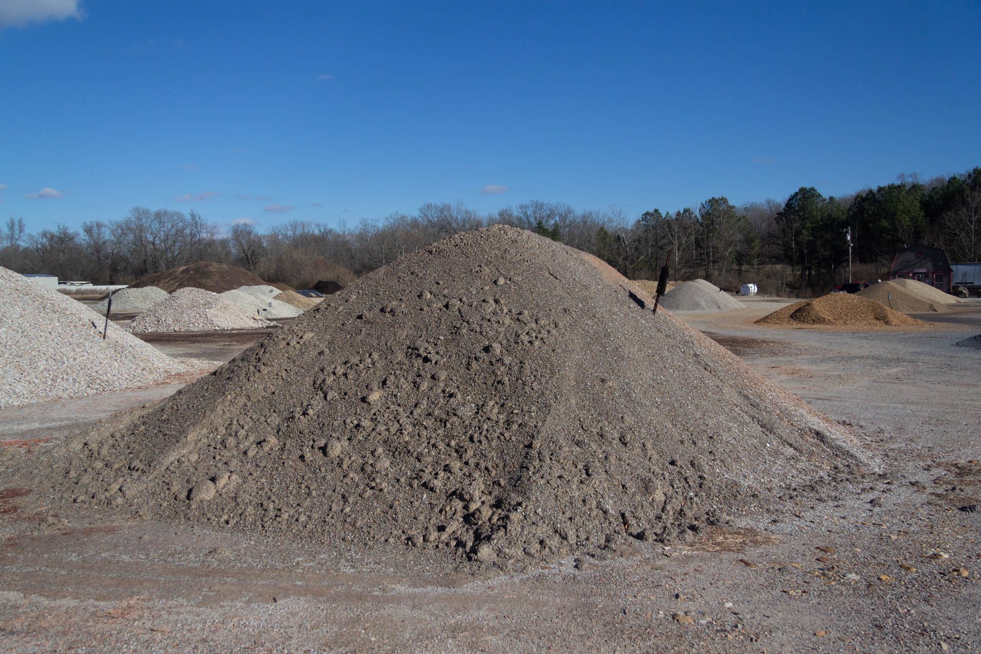 A pile of gravel is sitting on top of a dirt field.