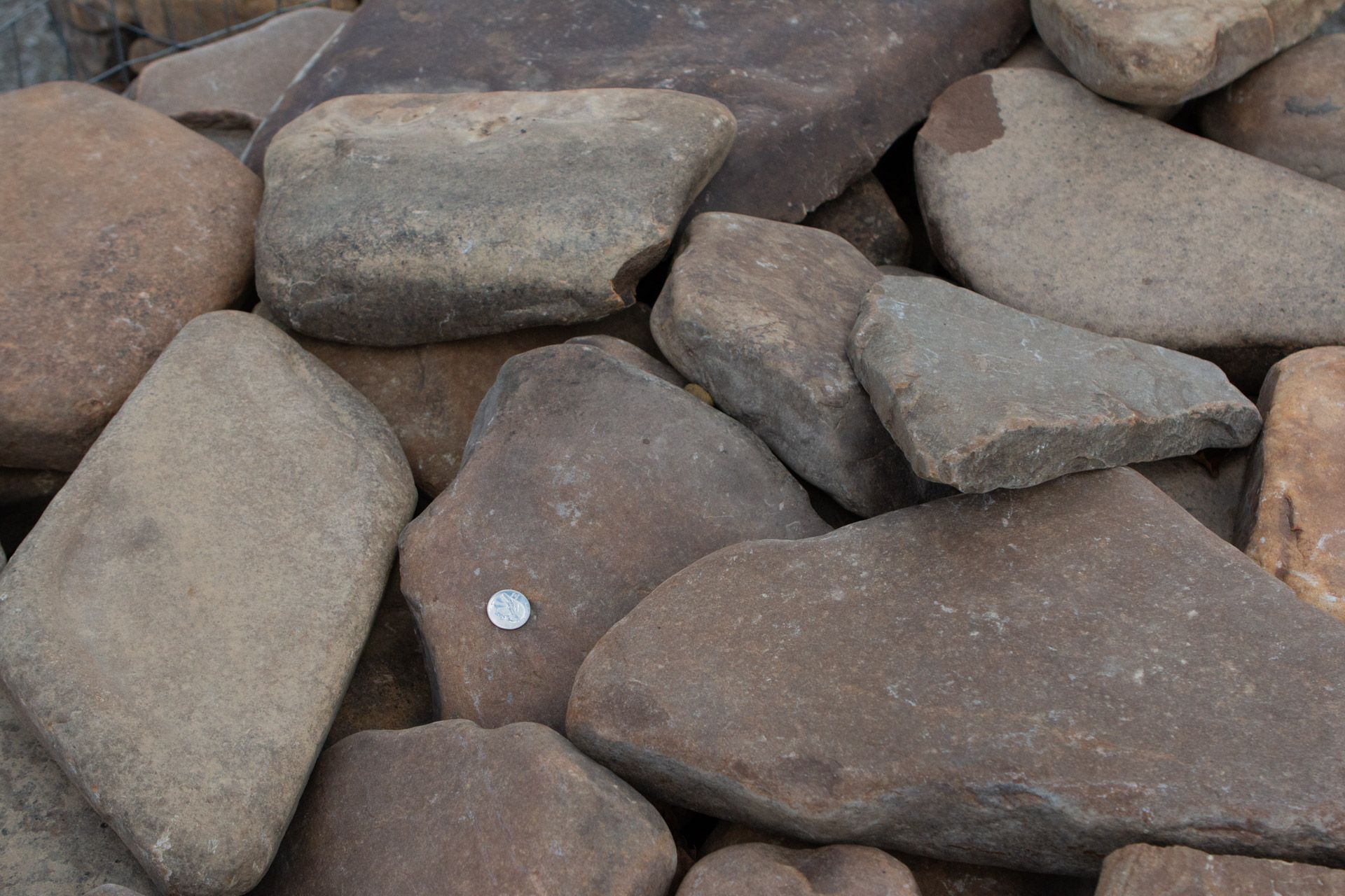 A pile of rocks with a coin in the middle