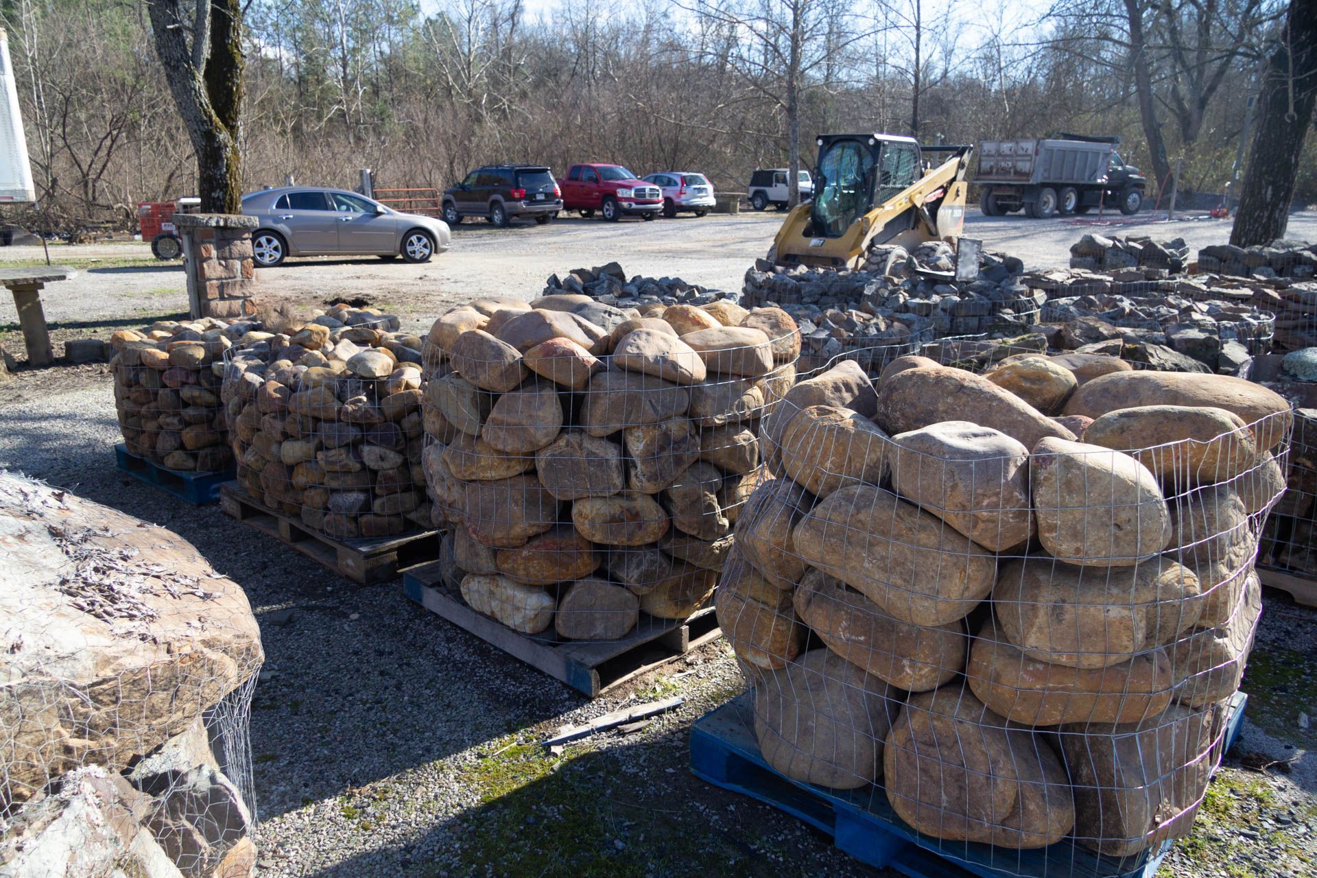 A pile of rocks is sitting on a pallet in a parking lot.