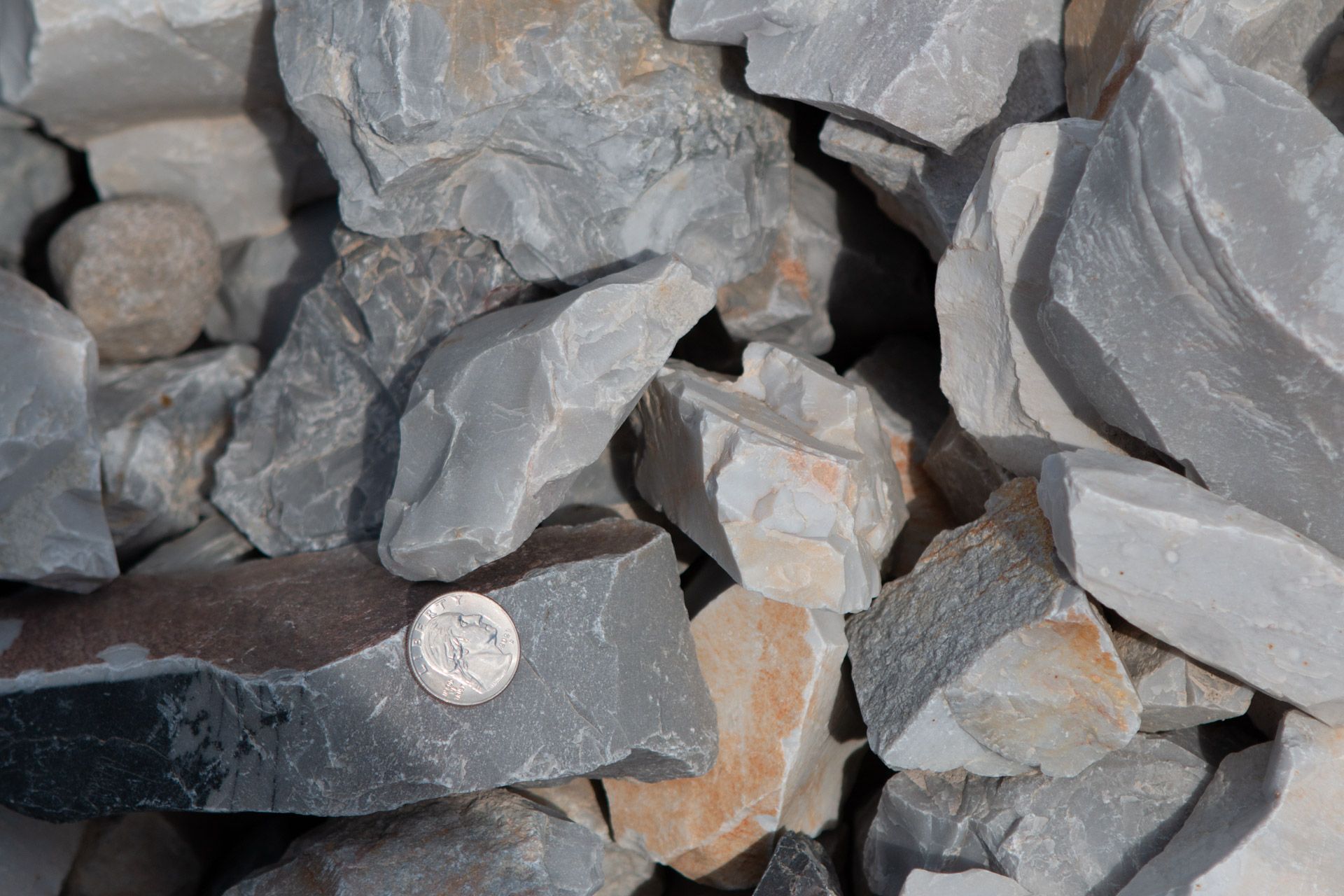 A pile of rocks with a penny in the middle.
