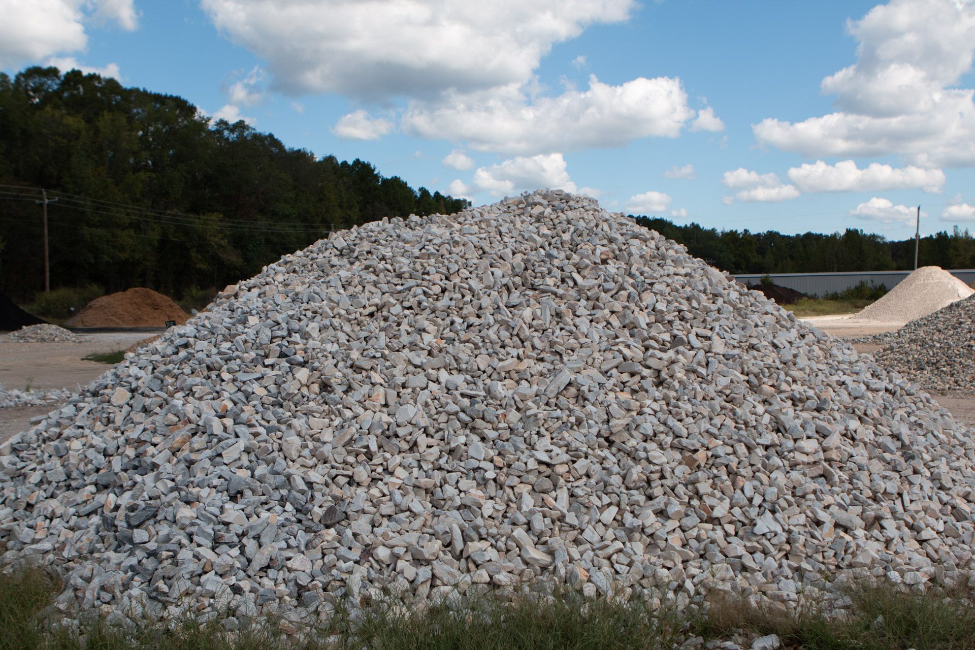 A large pile of gravel is sitting in a field