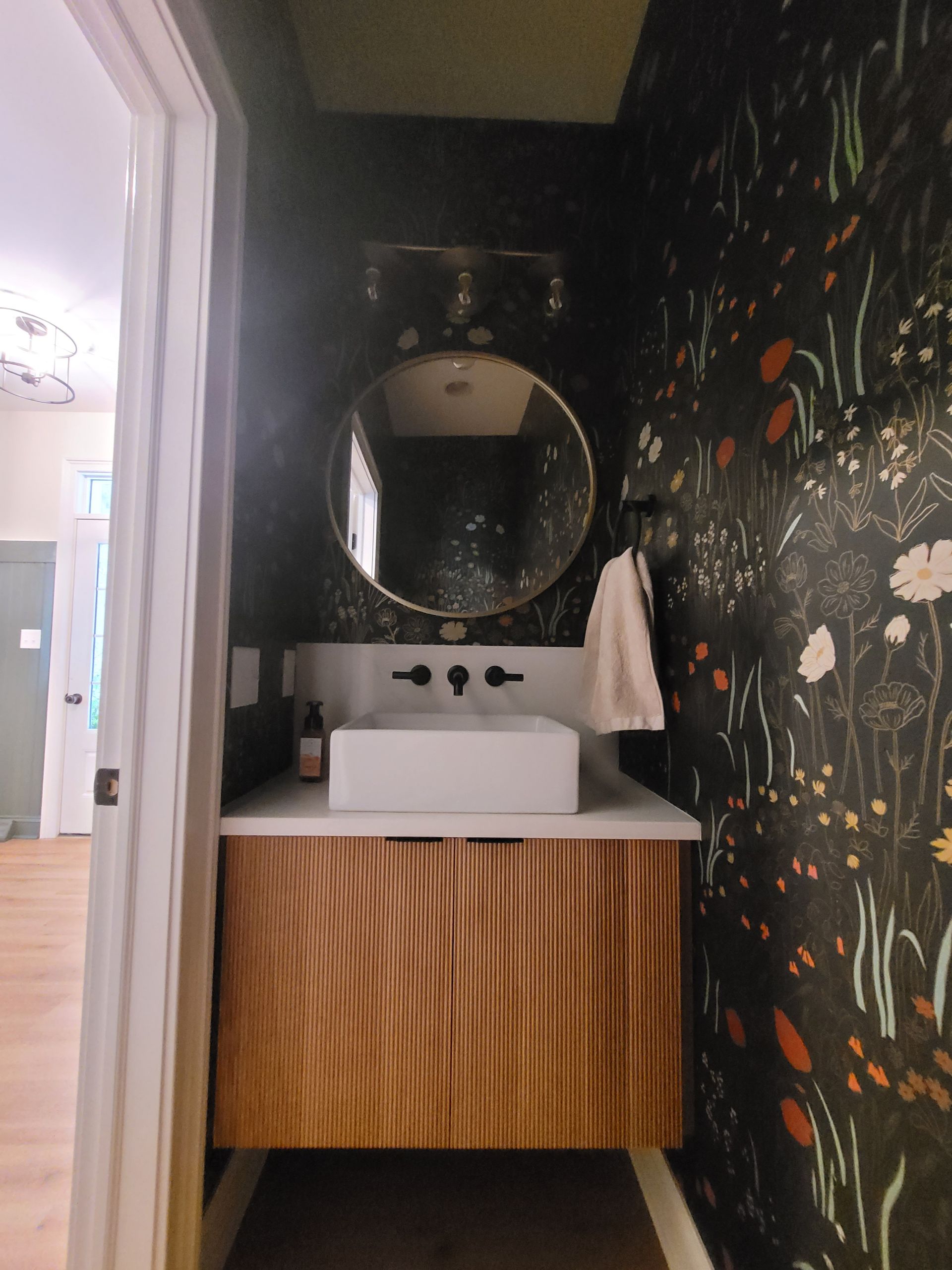 A kitchen with green cabinets and a coffee maker