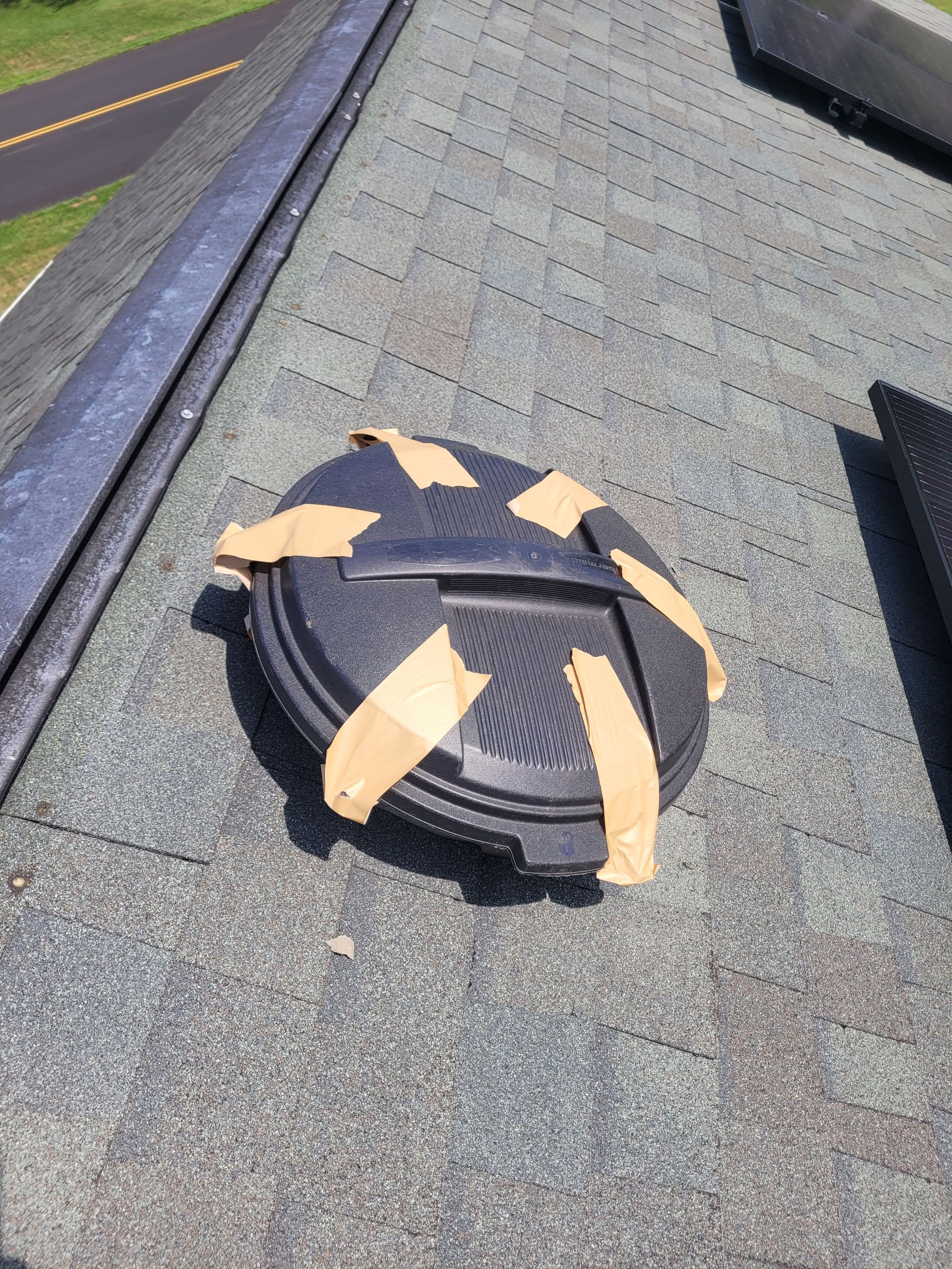 A roof vent is taped to the roof with tape