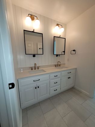 A bathroom with two sinks and two mirrors