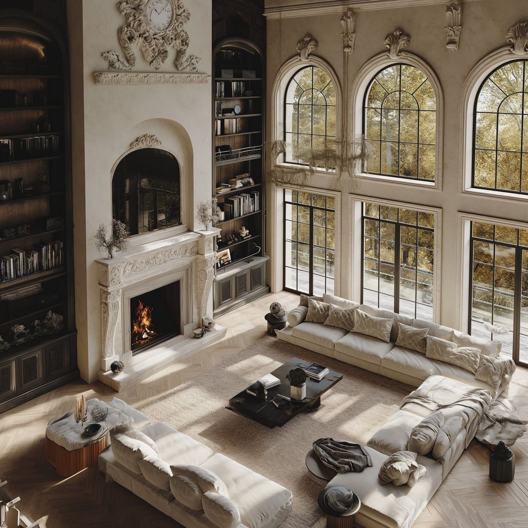 Elegant sunlit living room with tall arched windows, fireplace, and light sectional sofas around a coffee table