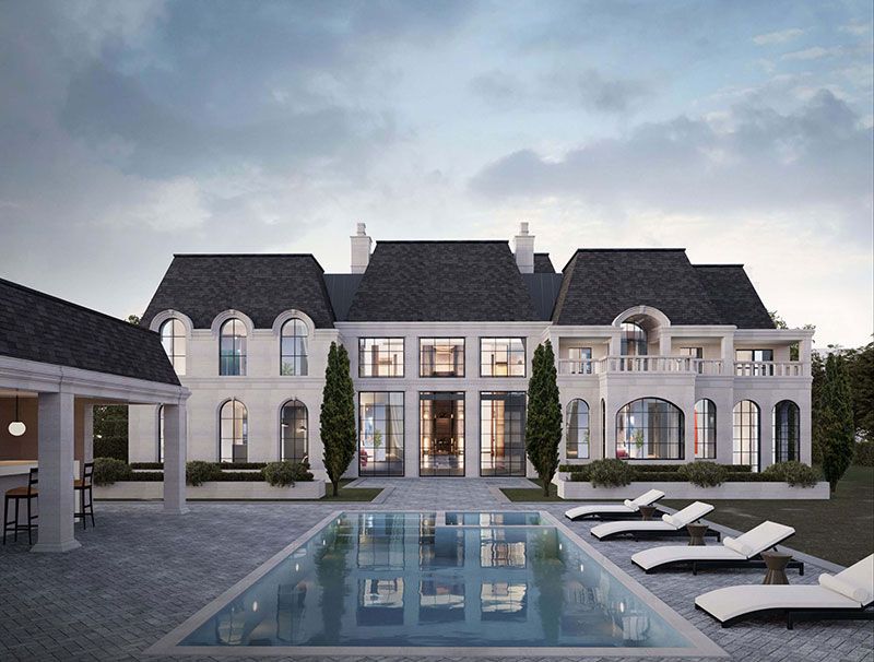 Elegant two-story white mansion with black roof at sunset, front garden and central walkway