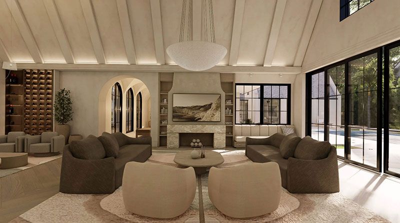 Elegant living room with beige seating, stone fireplace, large windows, and high vaulted ceiling