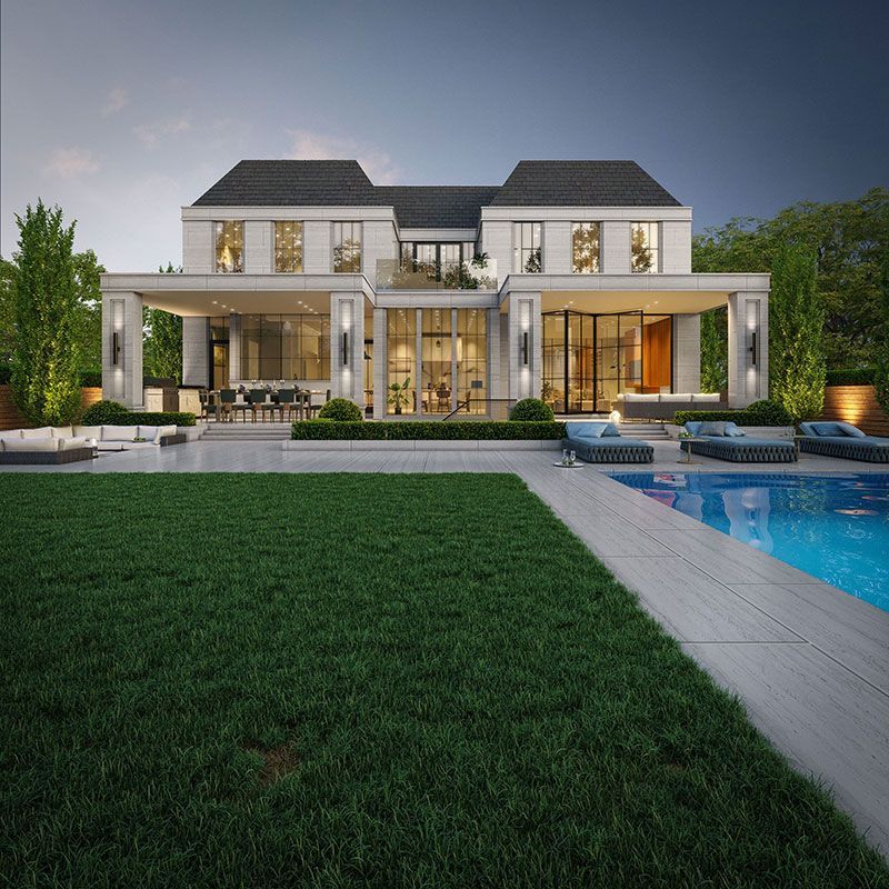 Modern luxury mansion with a lit patio, pool, and manicured lawn at dusk