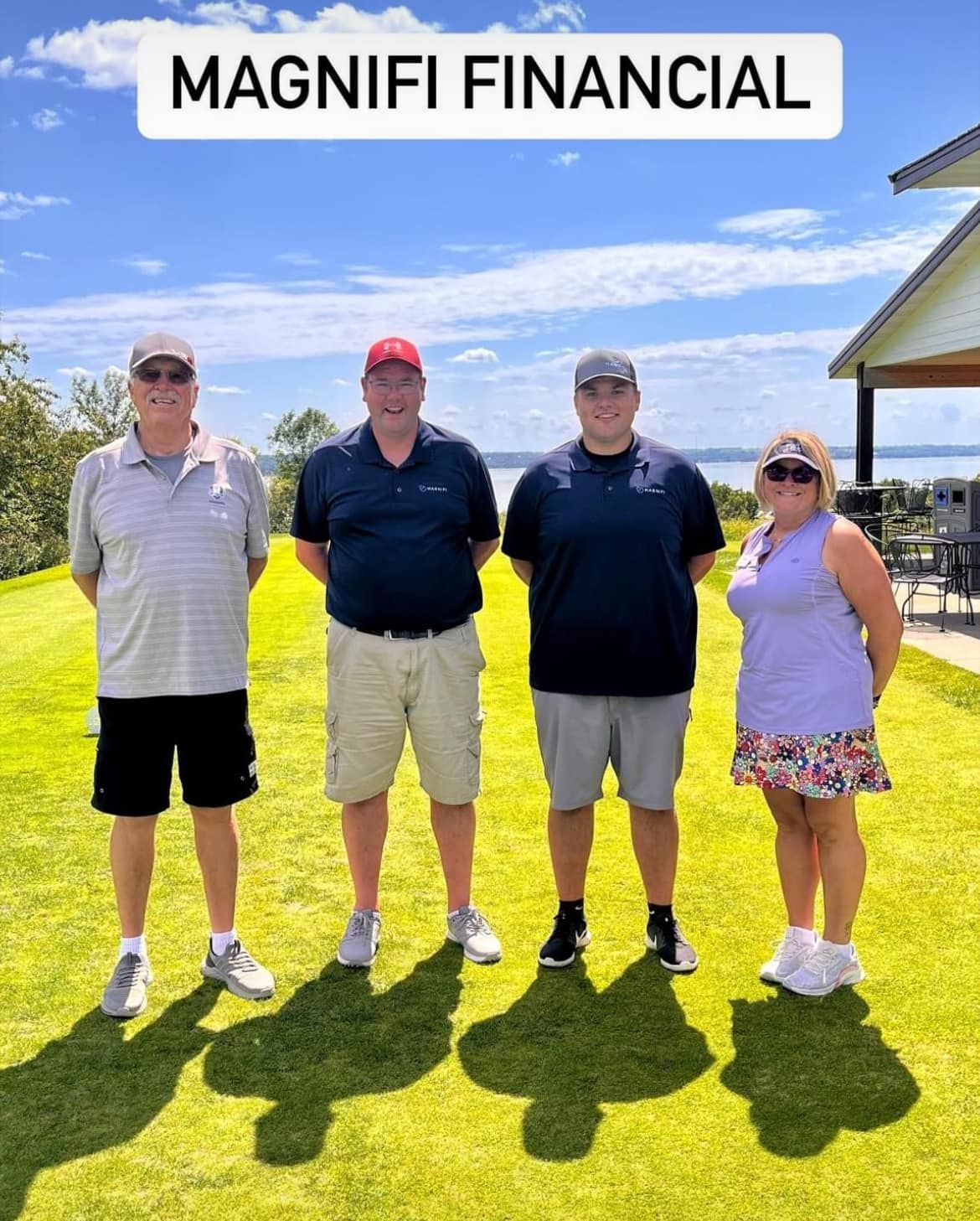 Four people stand in a line on a grassy hill under a blue sky, text above reads 