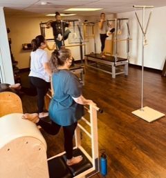 Pilates Small Group Mixed Apparatus Class on Classical Gratz Pilates equipment including Cadillacs and ladder barrels.