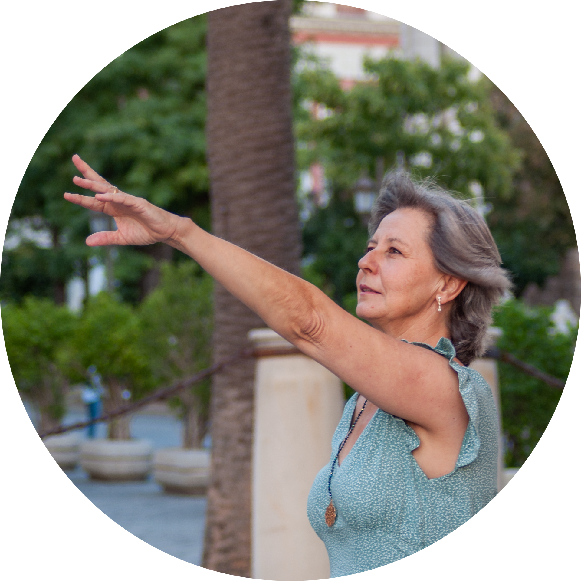 A woman in a green dress is reaching out her arm