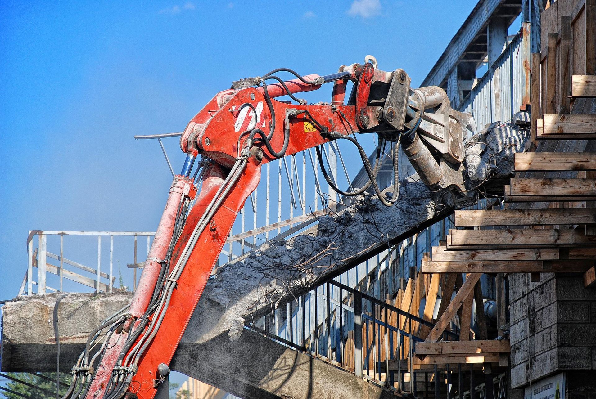 a red machine is working on a building