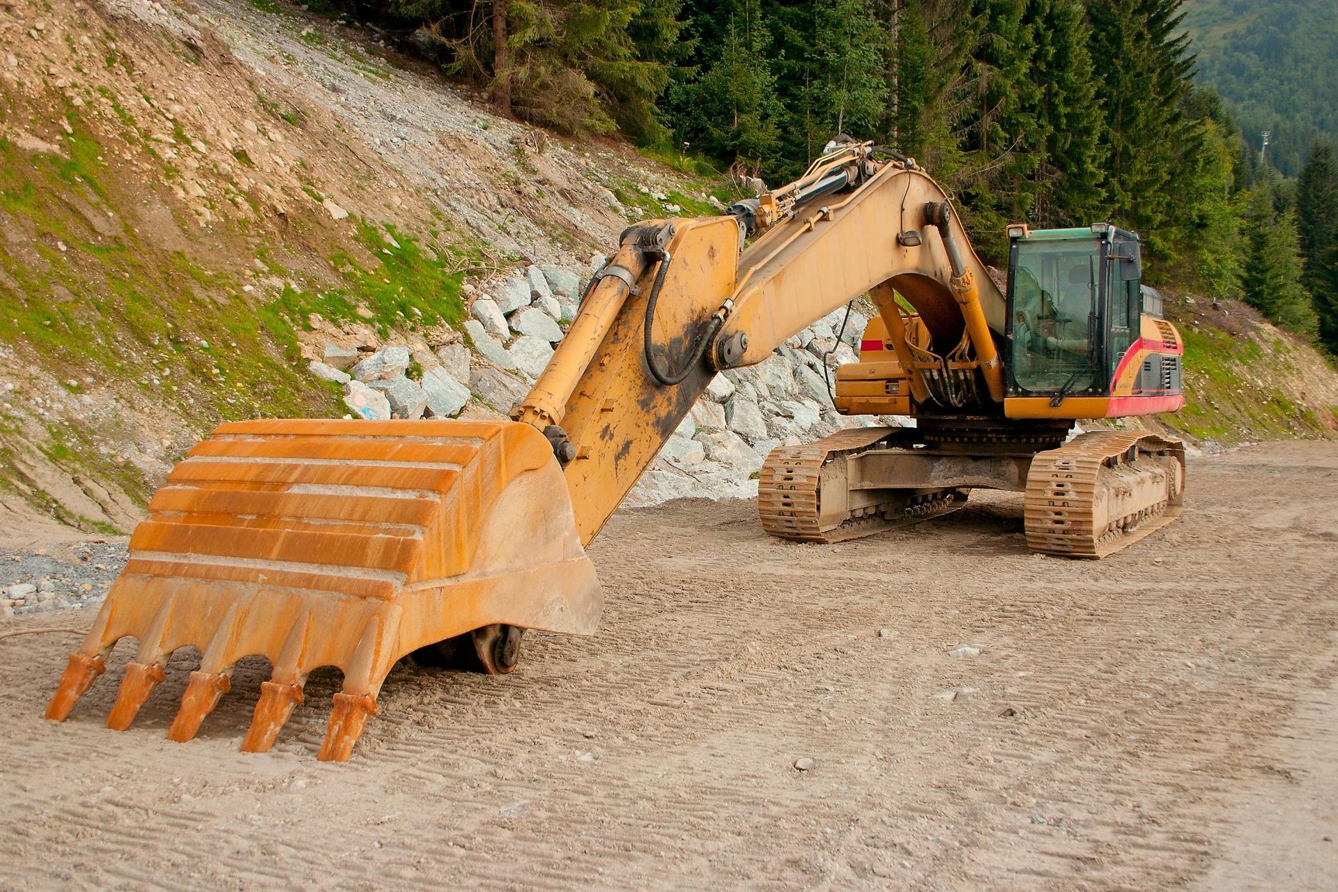 a bulldozer is parked on a dirt road