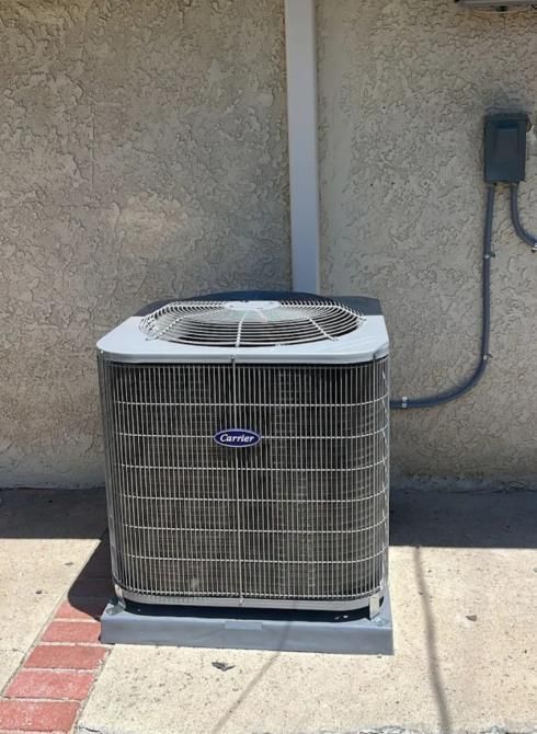 Diligent HVAC technician inspecting a residential AC unit for optimal performance and efficiency.