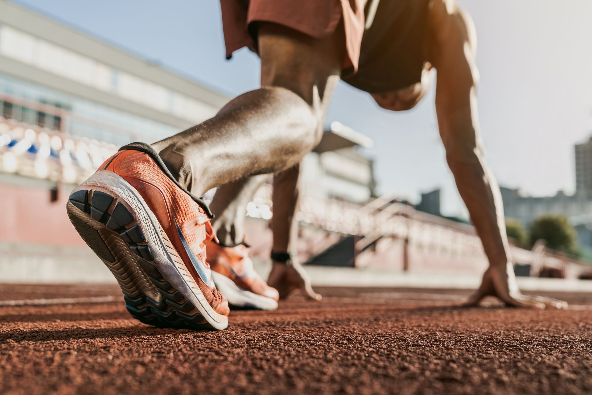 A man is getting ready to run on a track.