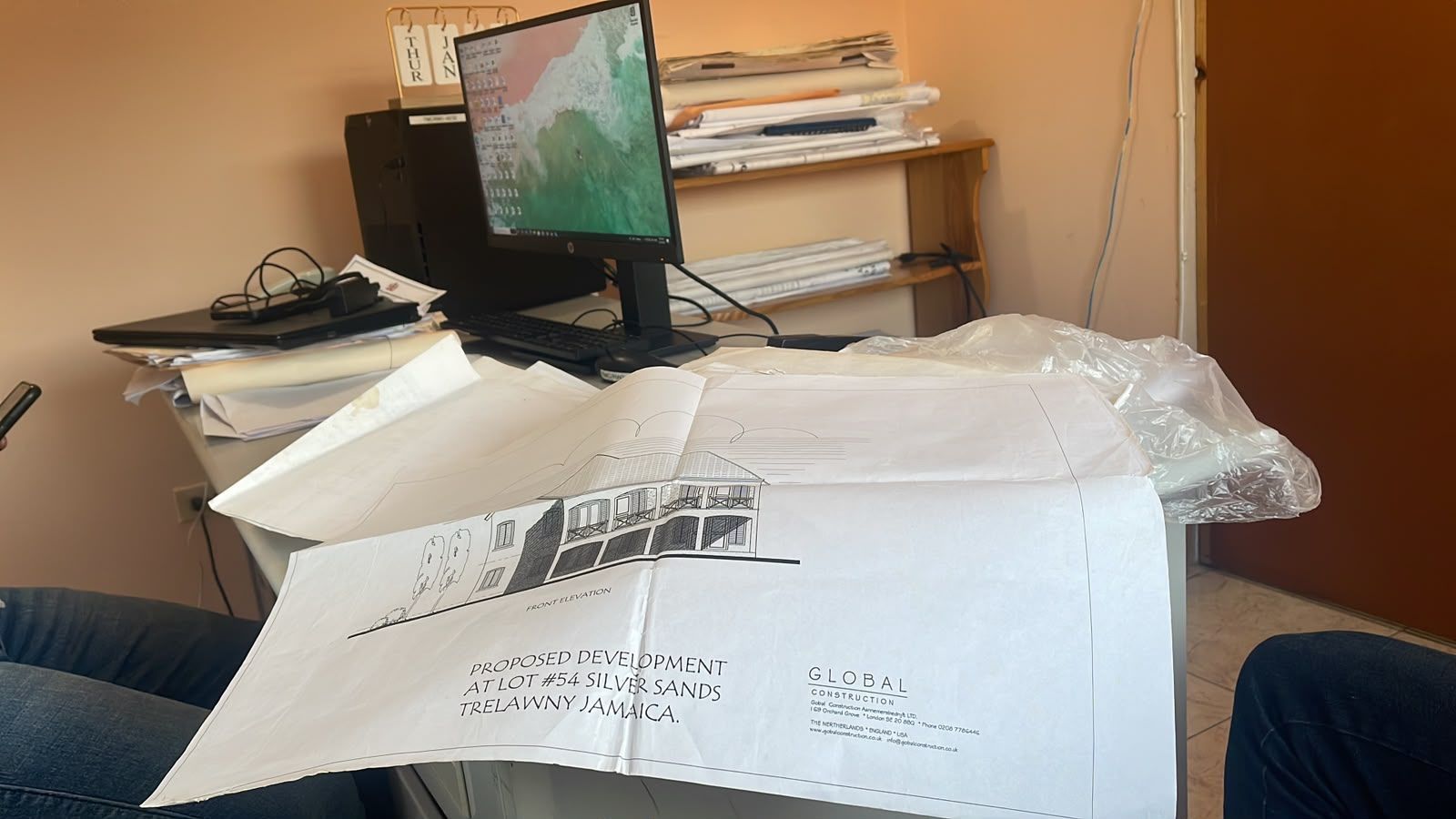 Architectural building plans on office desk