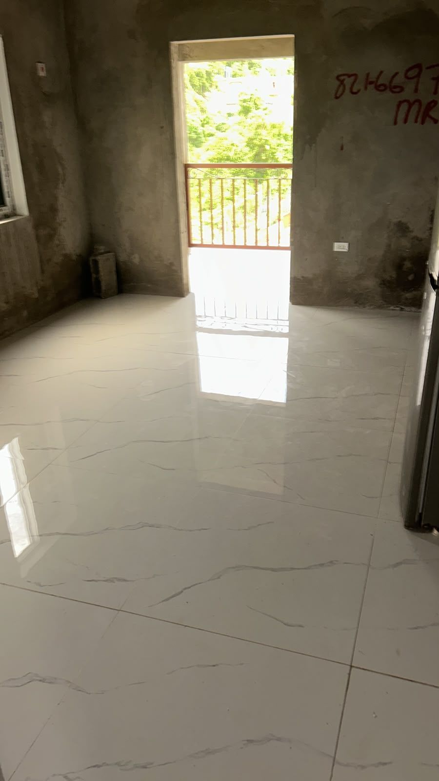 Finished tile floor with balcony view