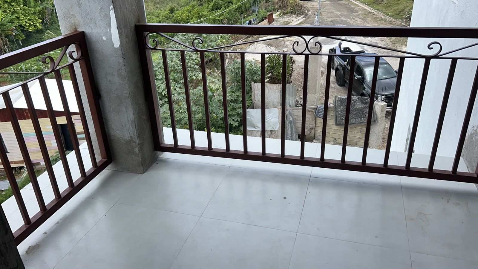 Upper floor balcony with ironwork railing