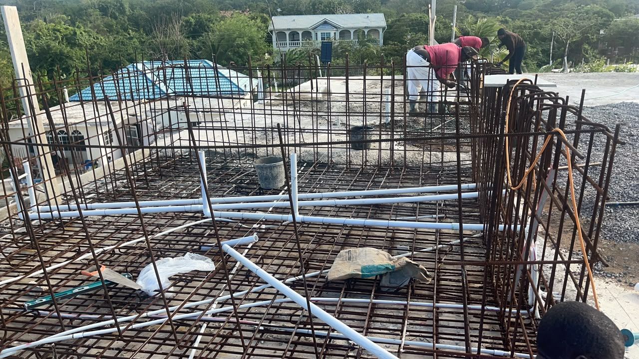 Rooftop rebar and concrete pour with pool below